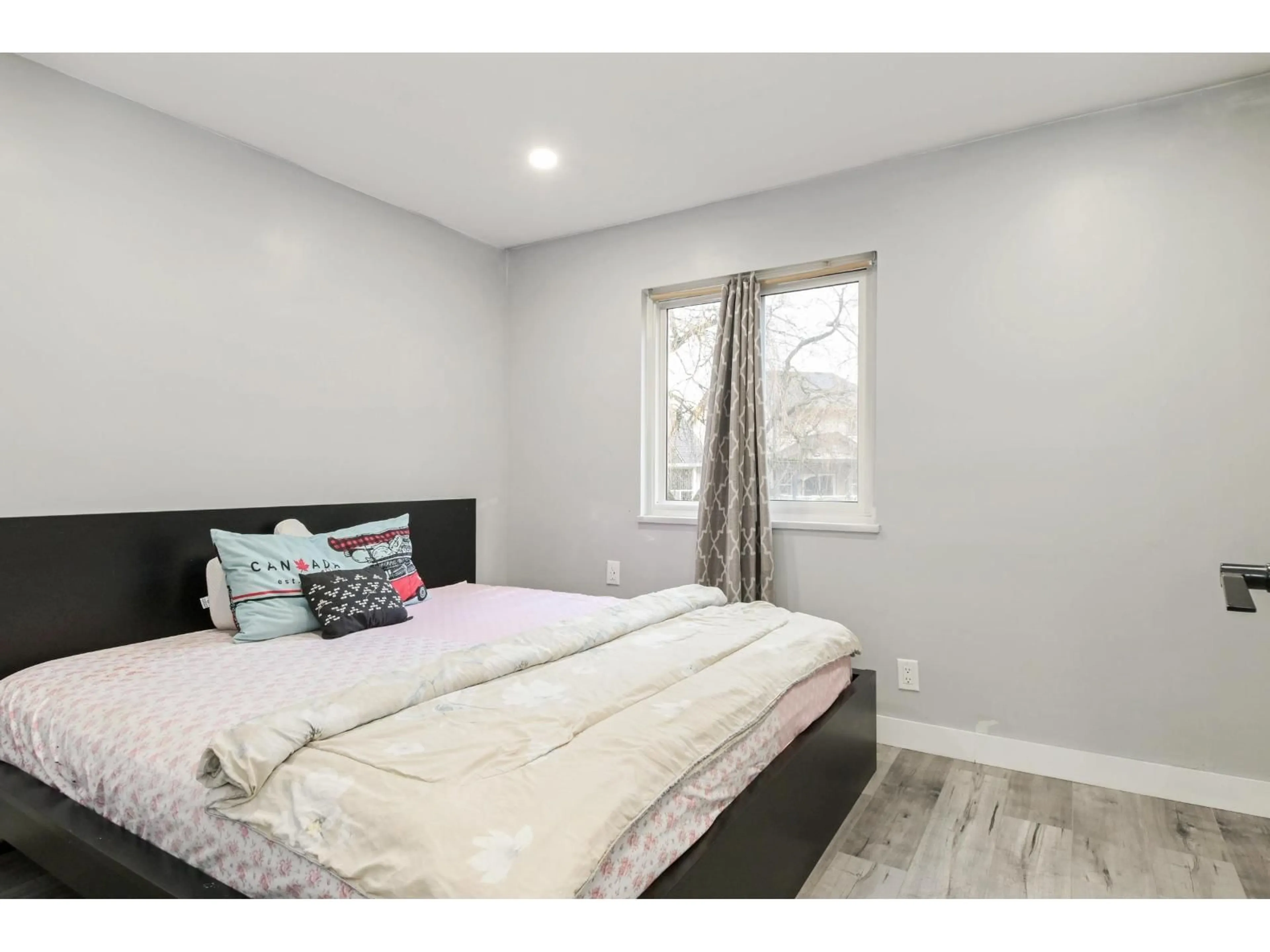 Bedroom with bed, wood/laminate floor for 6068 BROOKS CRESCENT, Surrey British Columbia V3S7L1