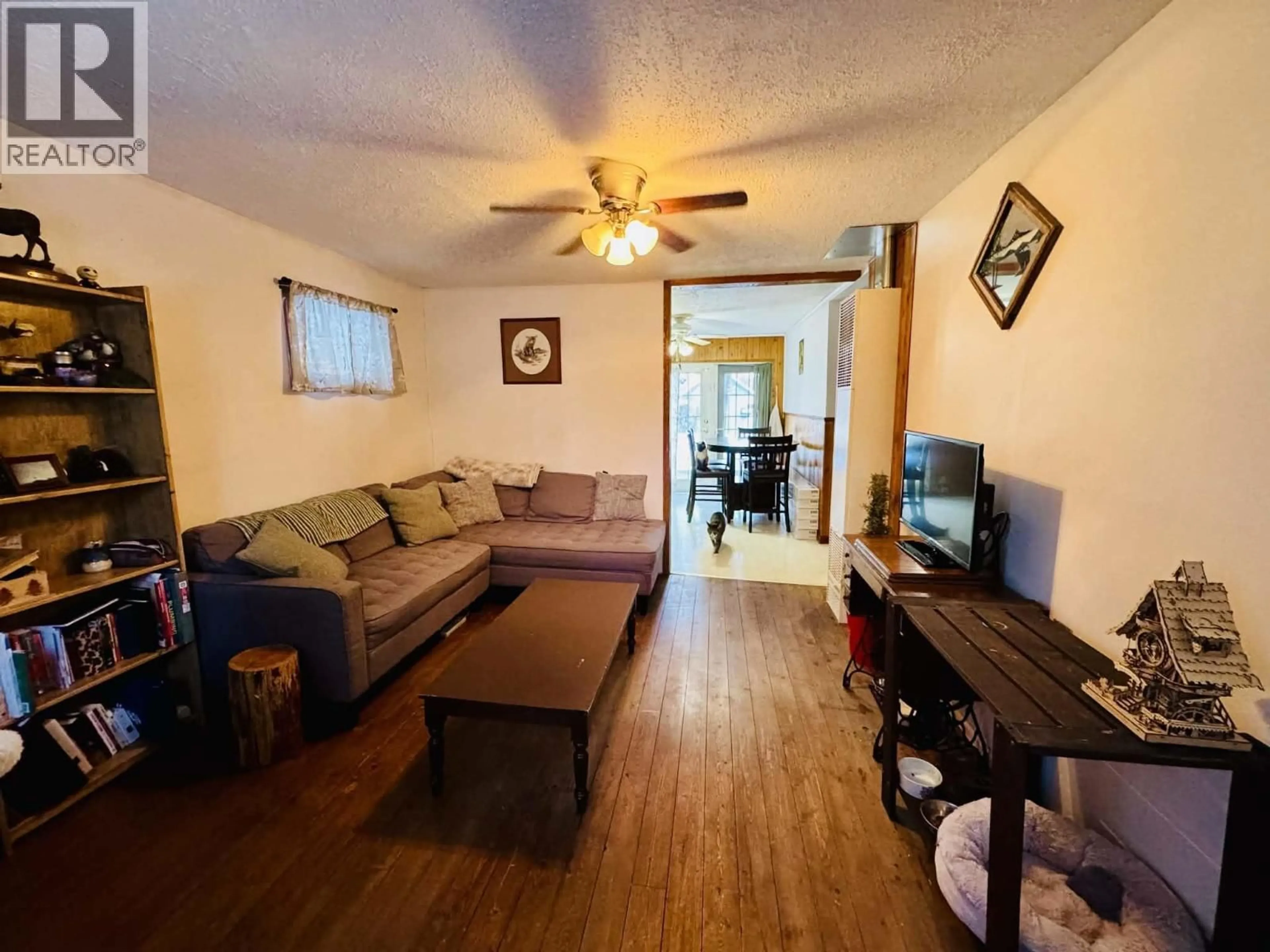 Living room with furniture, wood/laminate floor for 8143 99 AVENUE, Fort St. John British Columbia V1J1S6