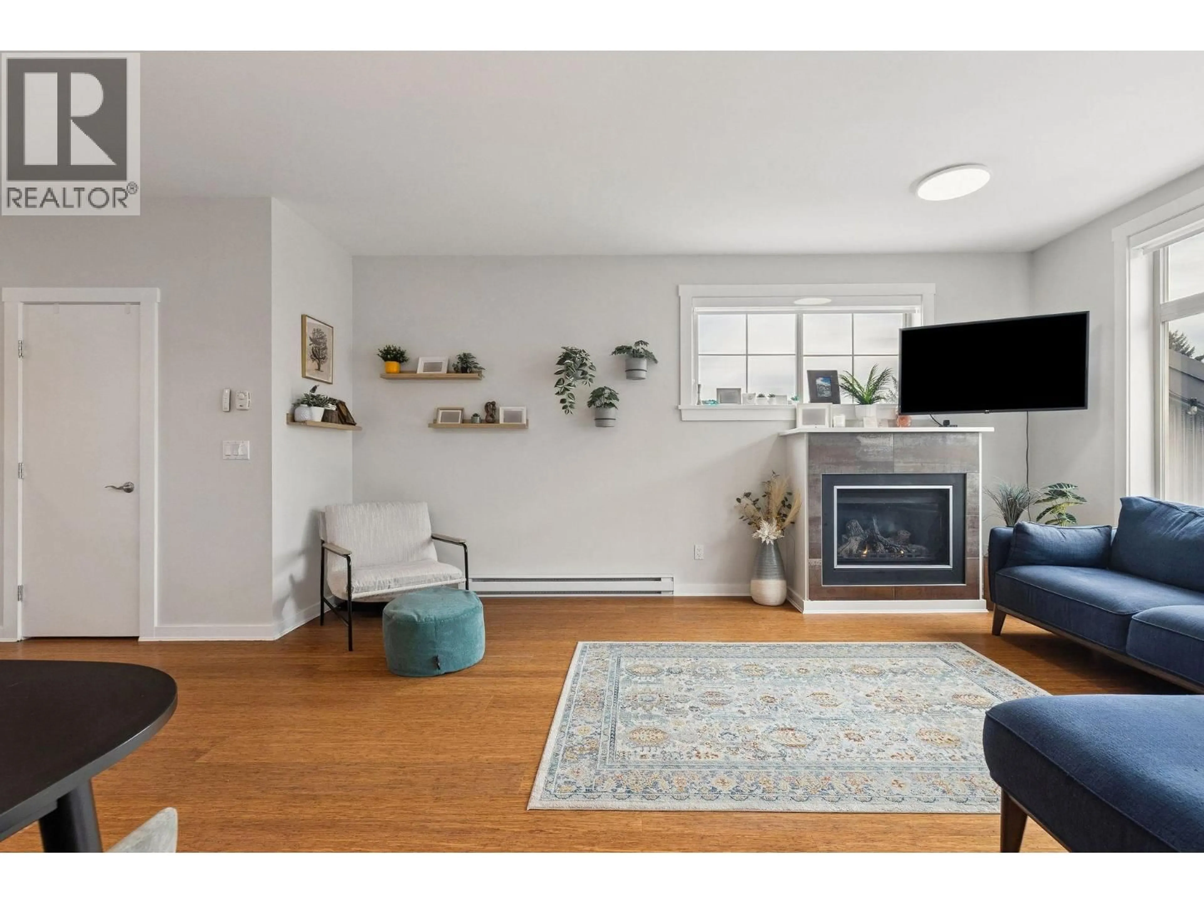 Living room with furniture, wood/laminate floor for 220 - 6111 LONDON ROAD, Richmond British Columbia V7E3S3