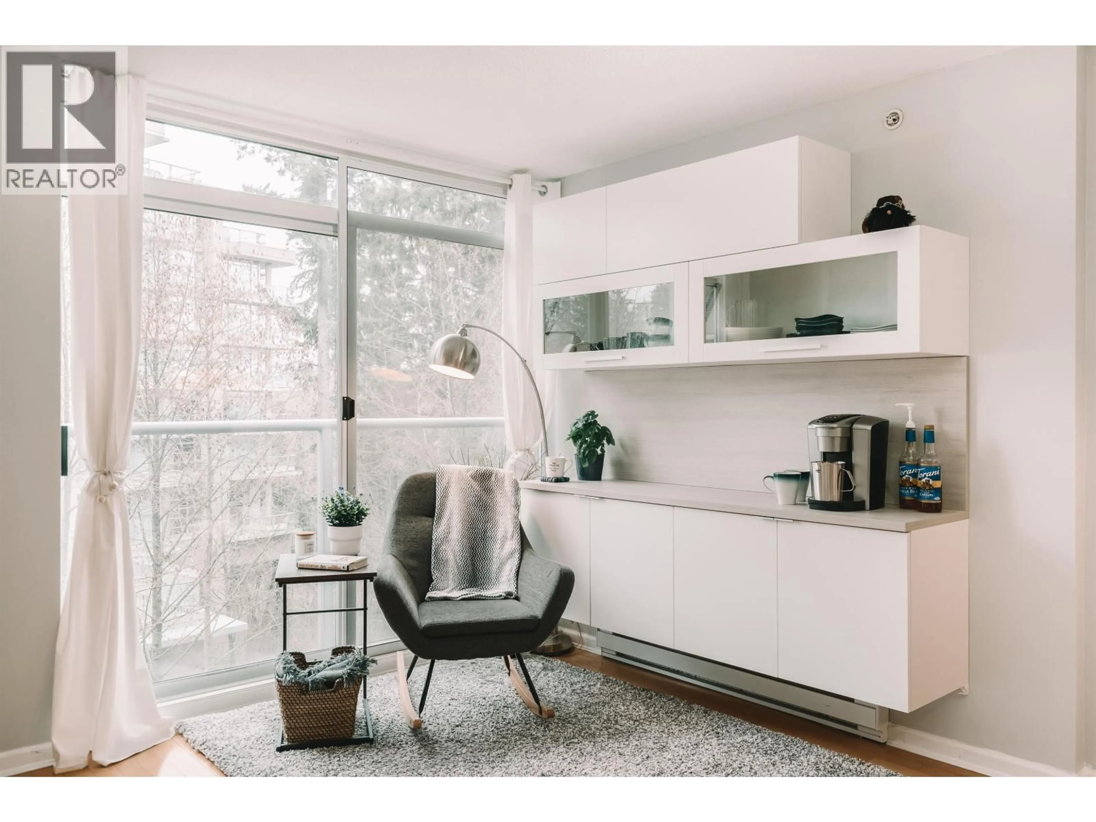 Living room with furniture, wood/laminate floor for 302 - 9288 UNIVERSITY CRESCENT, Burnaby British Columbia V5A4X7