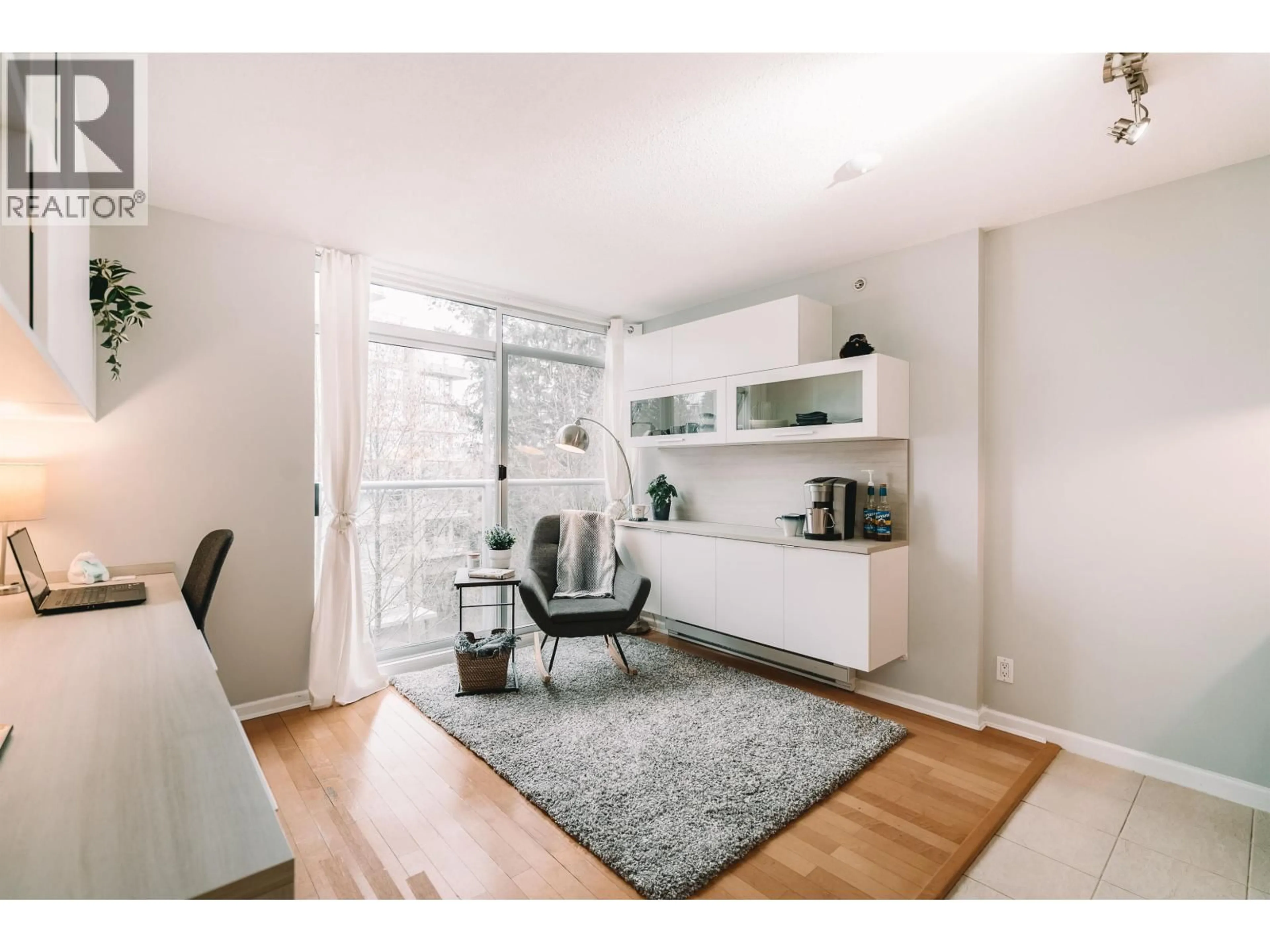 Living room with furniture, wood/laminate floor for 302 - 9288 UNIVERSITY CRESCENT, Burnaby British Columbia V5A4X7