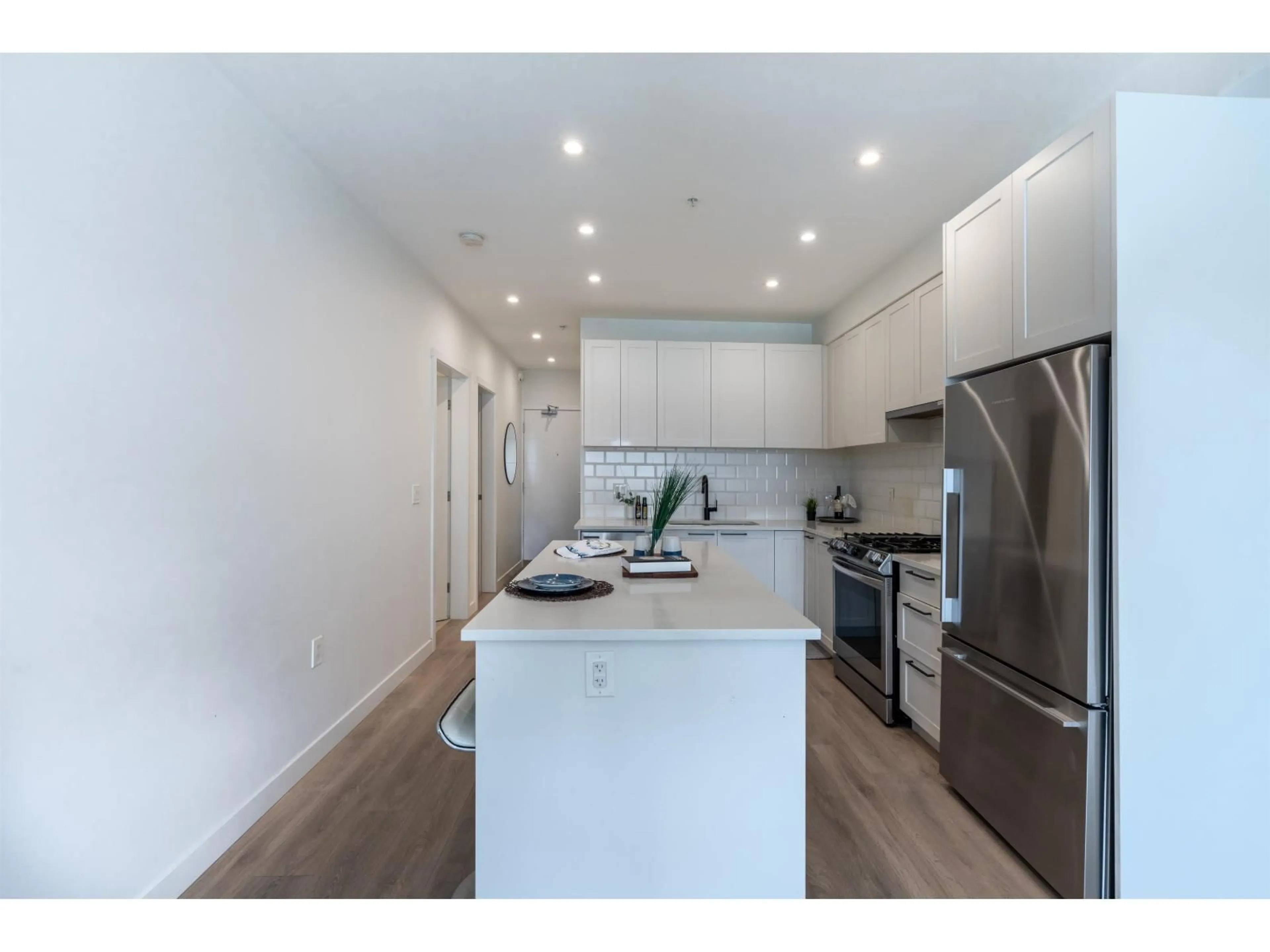 Open concept kitchen, wood/laminate floor for 230 - 5415 BRYDON CRESCENT, Langley British Columbia V3A0N4