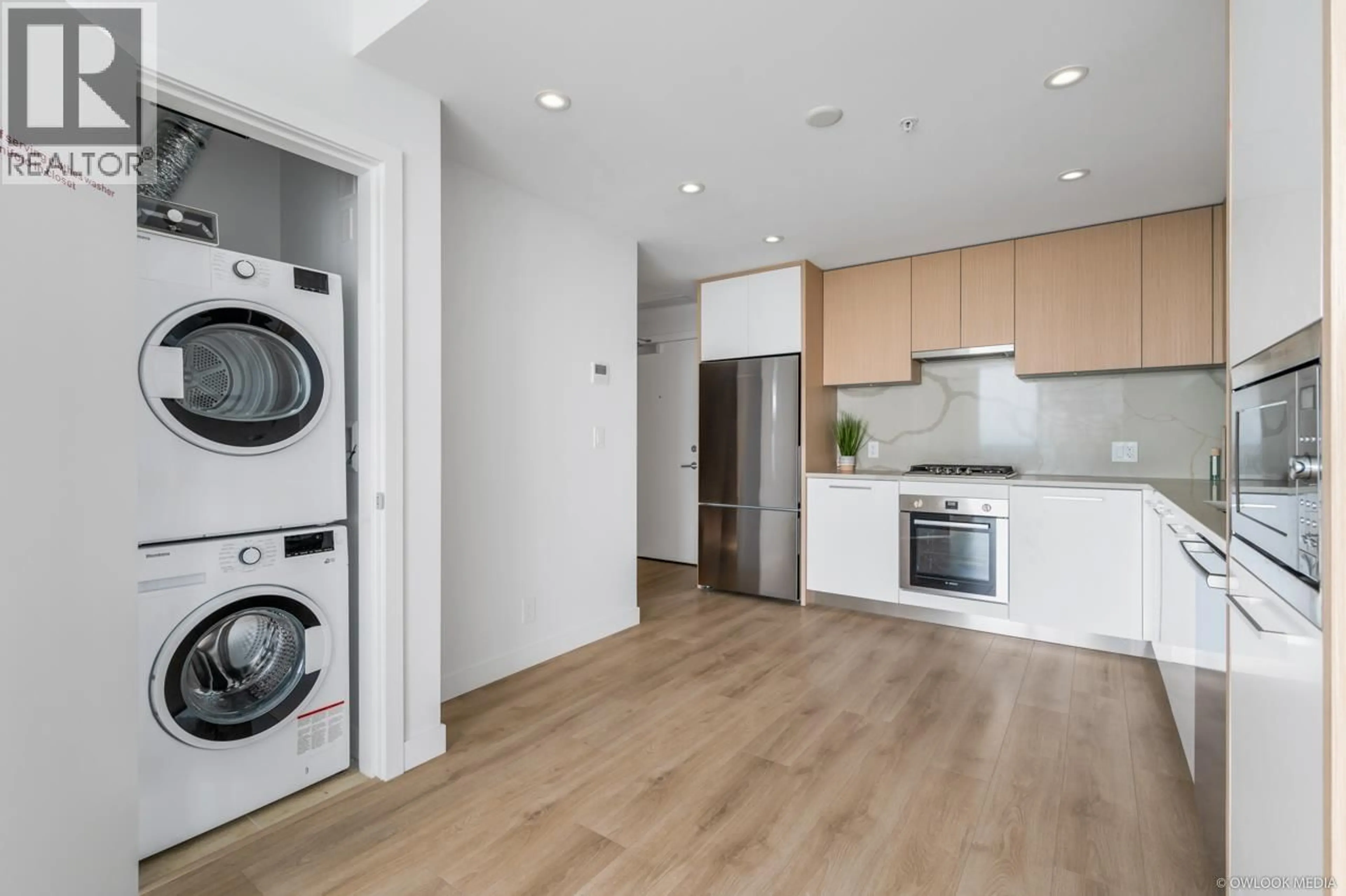 Kitchen with laundary machines, wood/laminate floor for 2607 - 567 CLARKE ROAD, Coquitlam British Columbia V3J0K7