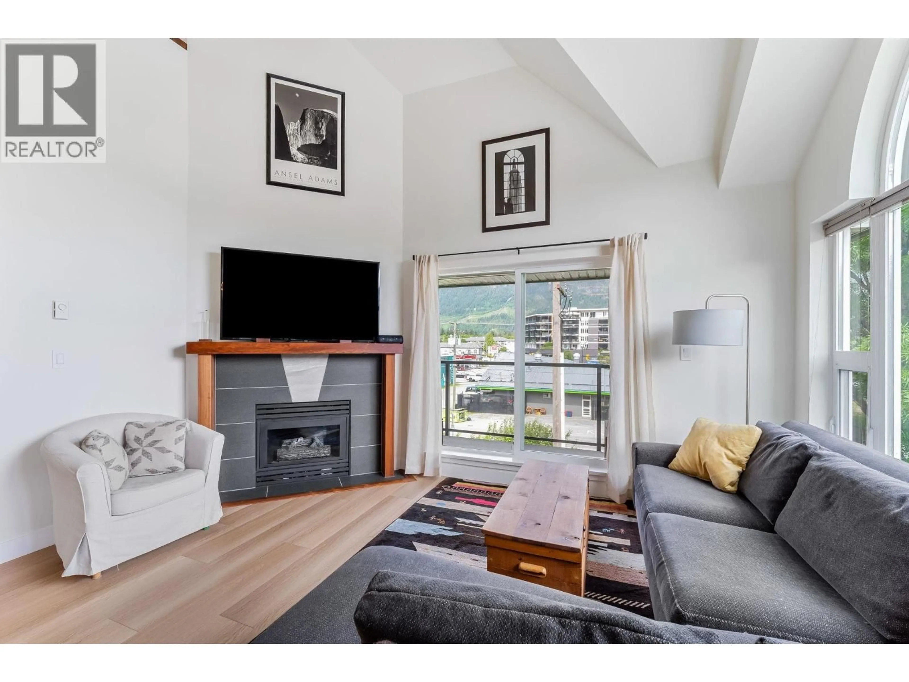 Living room with furniture, wood/laminate floor for 312 - 1466 PEMBERTON AVENUE, Squamish British Columbia V8B0K1