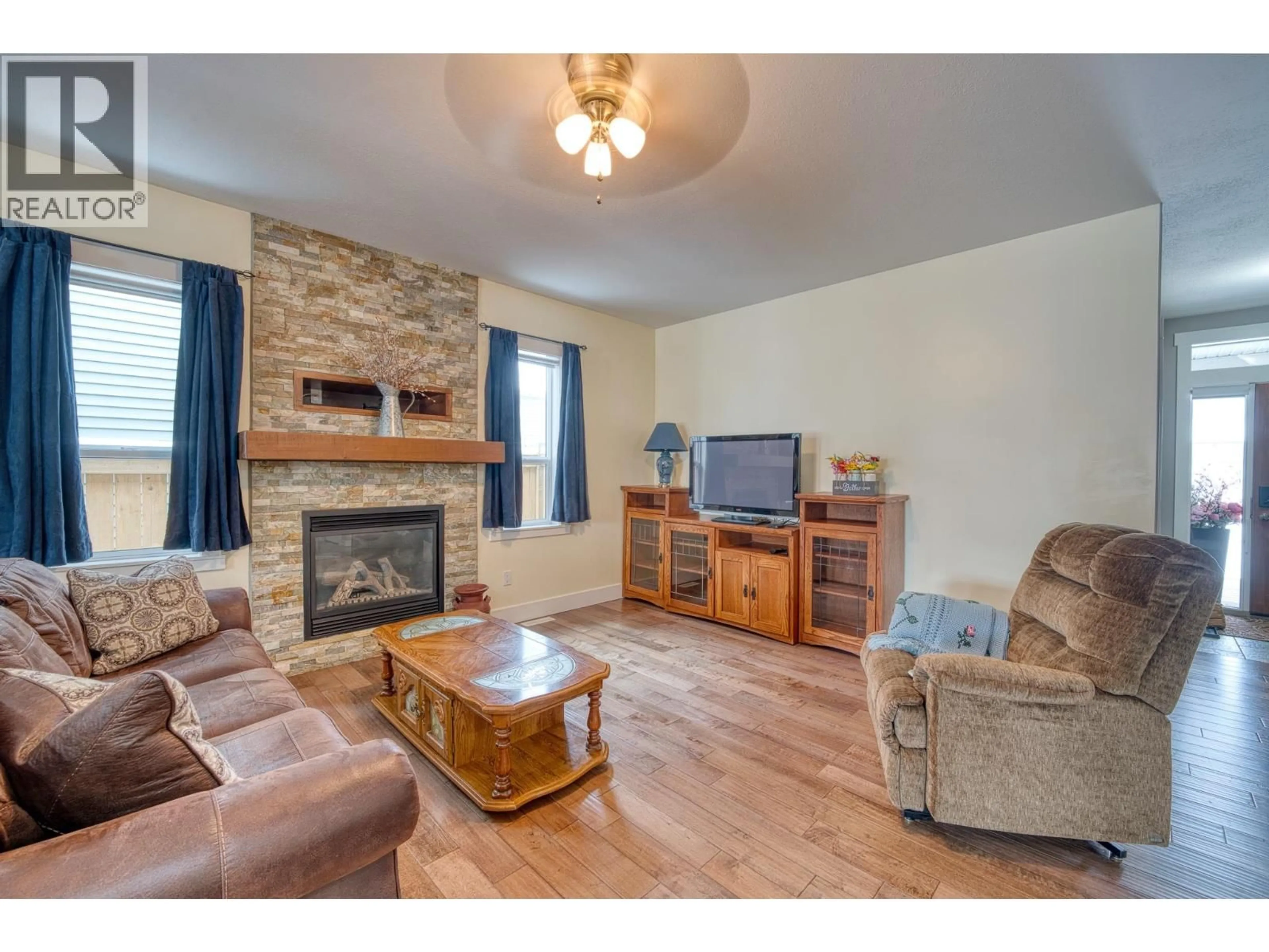 Living room with furniture, wood/laminate floor for 11719 103A STREET, Fort St. John British Columbia V1J0L4