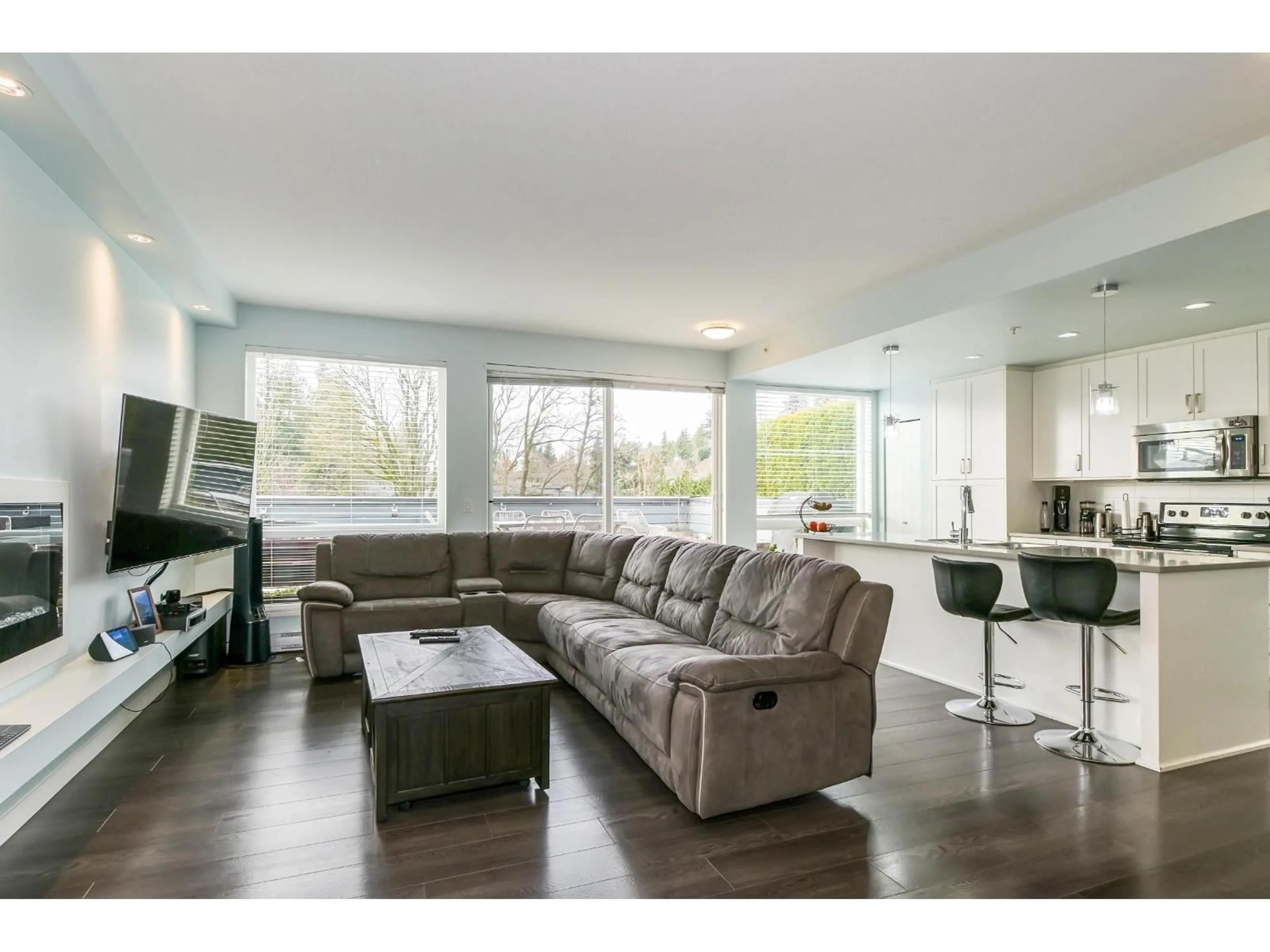 Living room with furniture, wood/laminate floor for 411 - 2242 WHATCOM ROAD, Abbotsford British Columbia V3G0G3