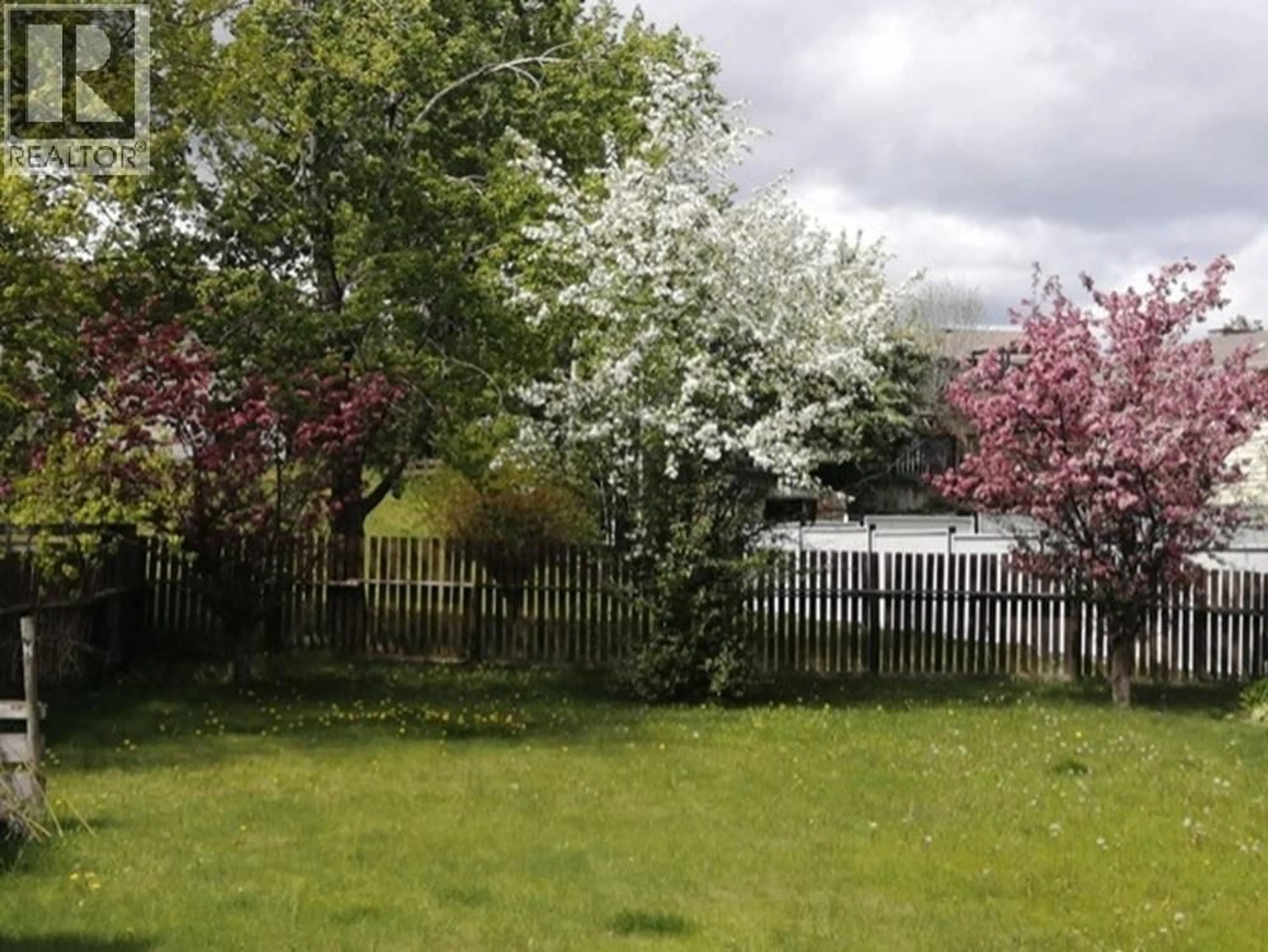 A pic from outside/outdoor area/front of a property/back of a property/a pic from drone, forest/trees view for 488 EVERGREEN CRESCENT, 100 Mile House British Columbia V0K2E0