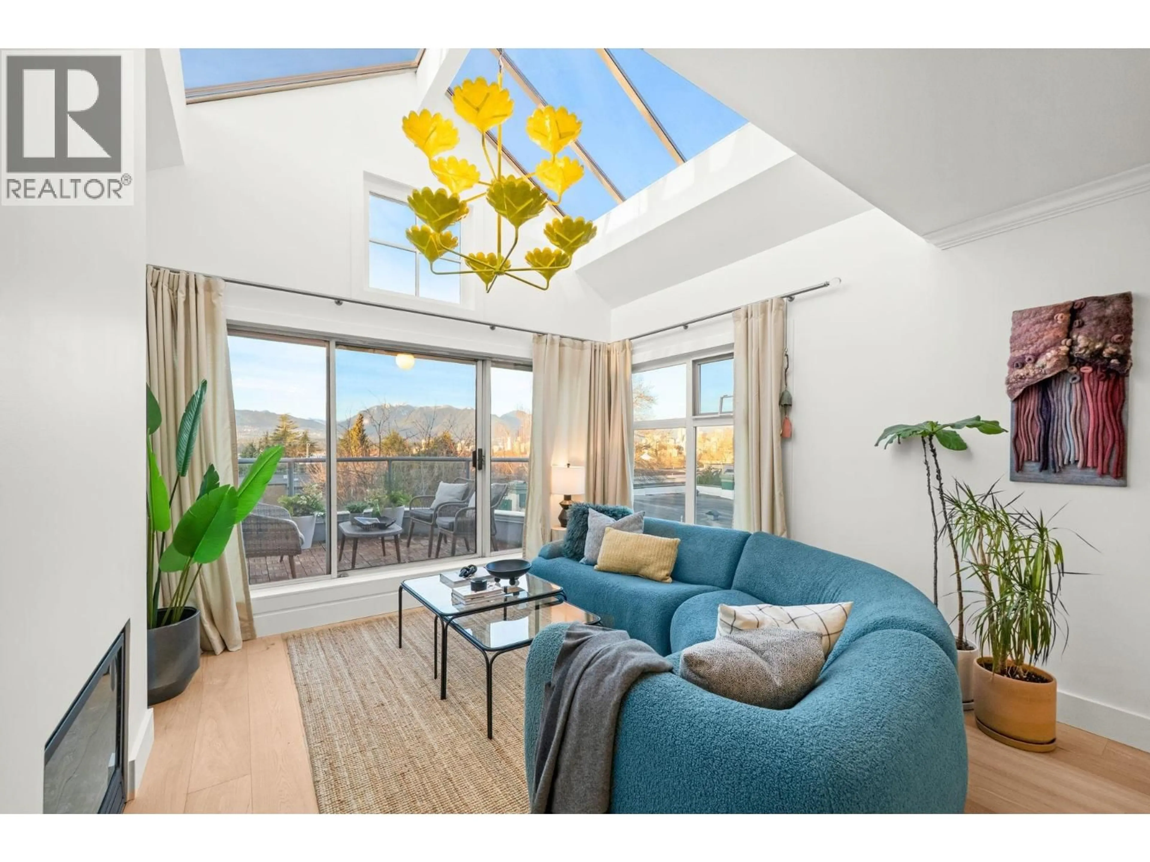 Living room with furniture, wood/laminate floor for 409 - 2250 3RD AVENUE, West Vancouver British Columbia V6K1L4