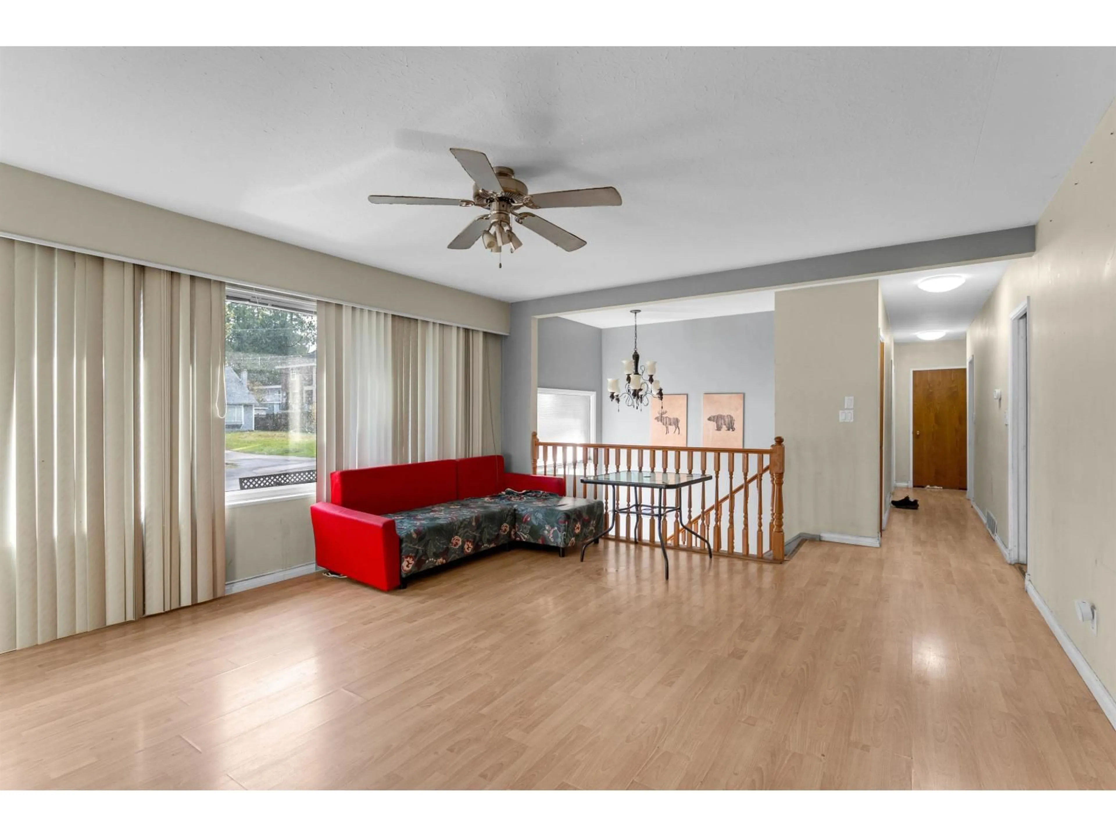 Living room with furniture, wood/laminate floor for 9939 119A STREET, Surrey British Columbia V3V4B3