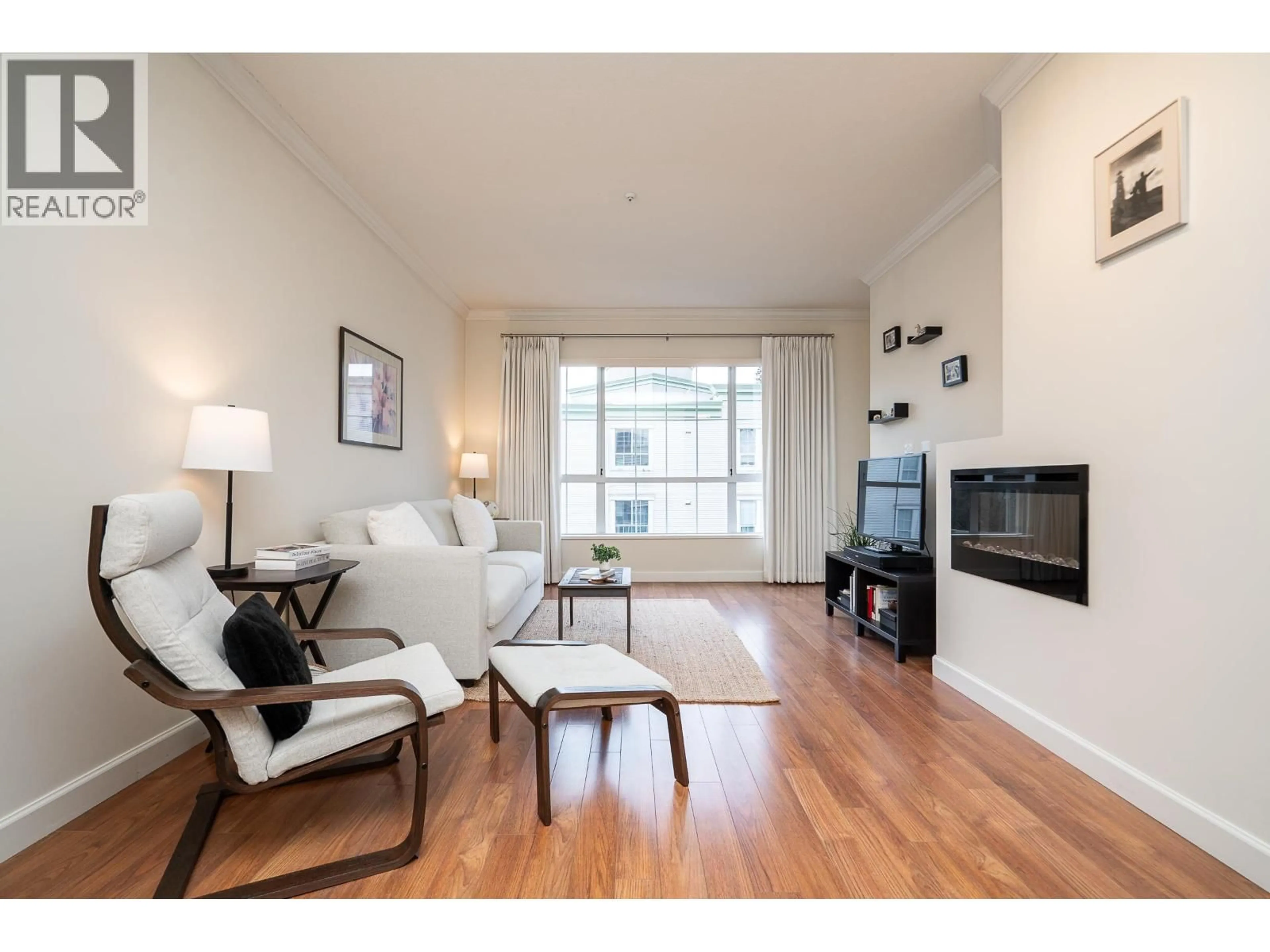 Living room with furniture, wood/laminate floor for 318 - 2985 PRINCESS CRESCENT, Coquitlam British Columbia V3B7P3