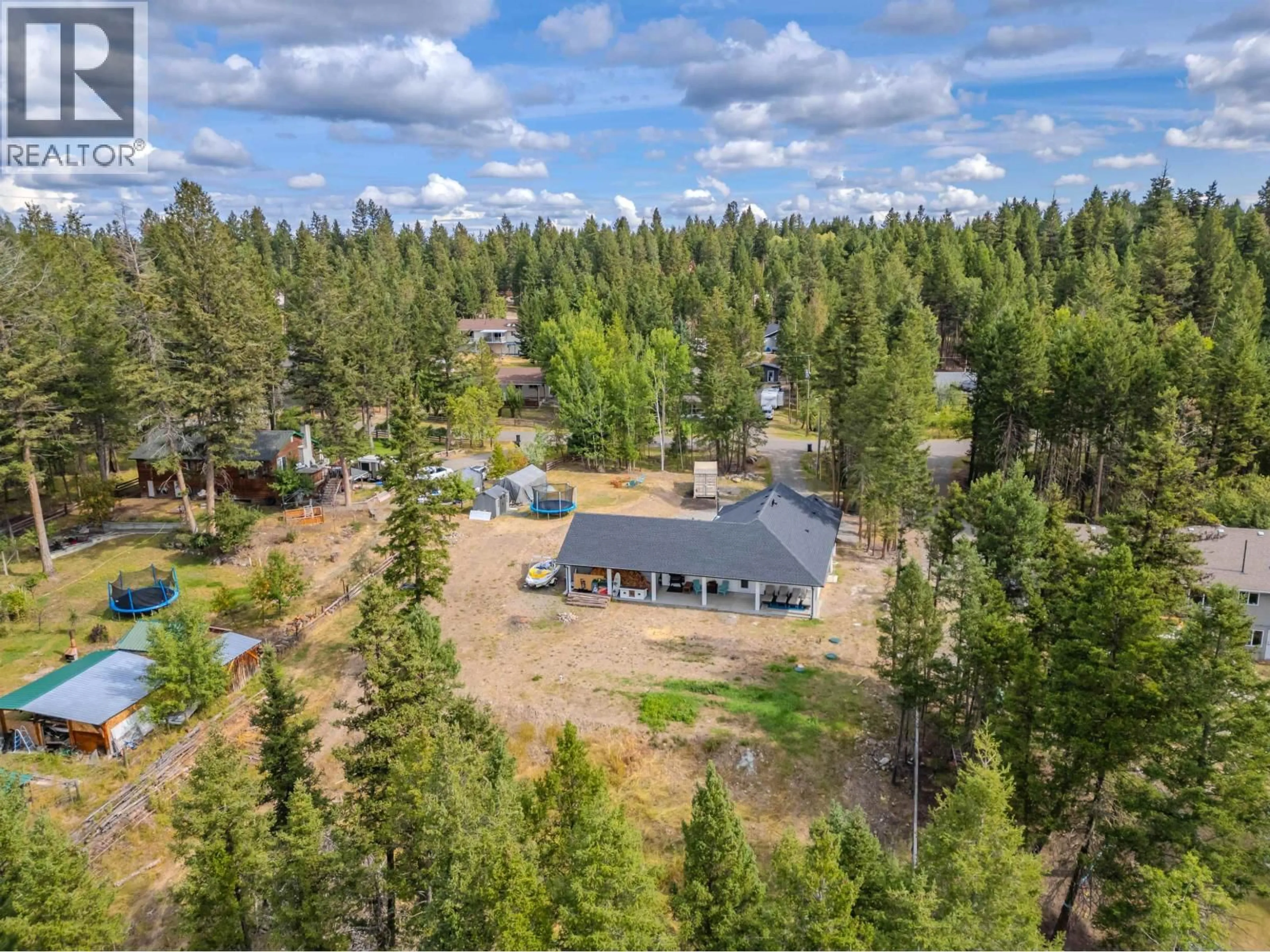 A pic from outside/outdoor area/front of a property/back of a property/a pic from drone, forest/trees view for 4878 GLOINNZUN DRIVE, 108 Mile Ranch British Columbia V0K2Z0
