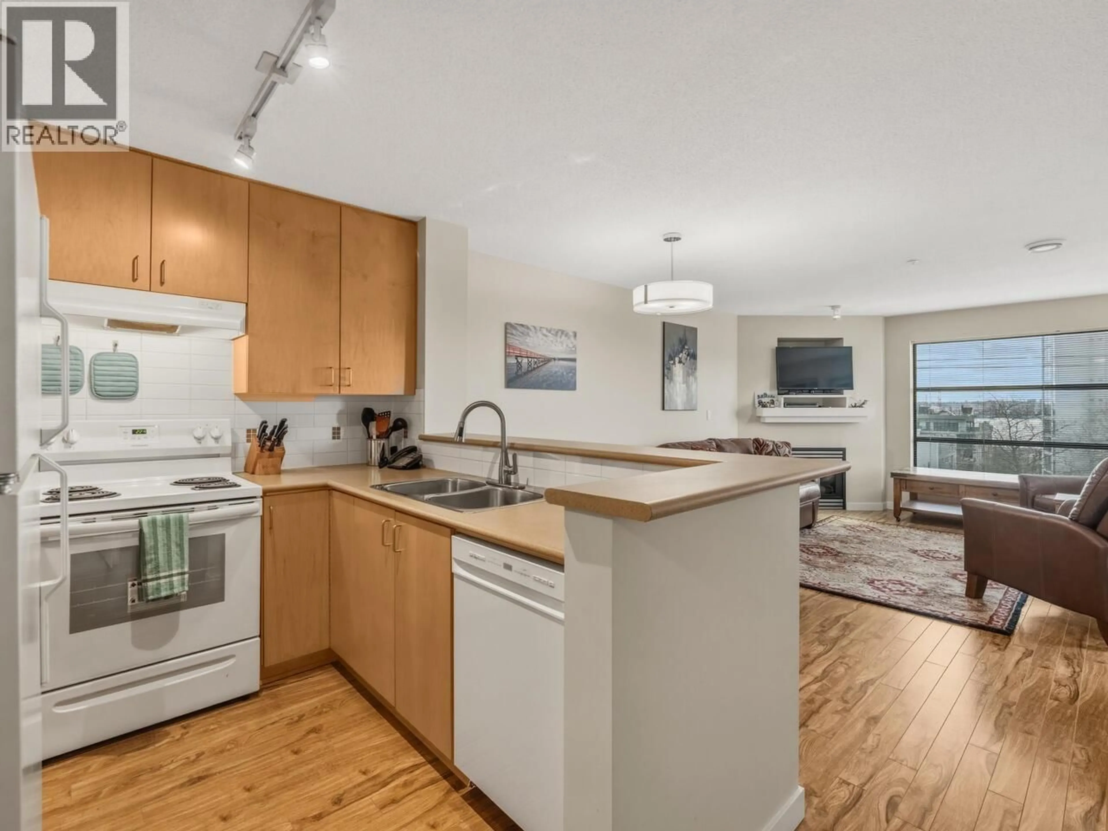 Open concept kitchen, wood/laminate floor for 402 - 124 3RD STREET, North Vancouver British Columbia V7M1E8