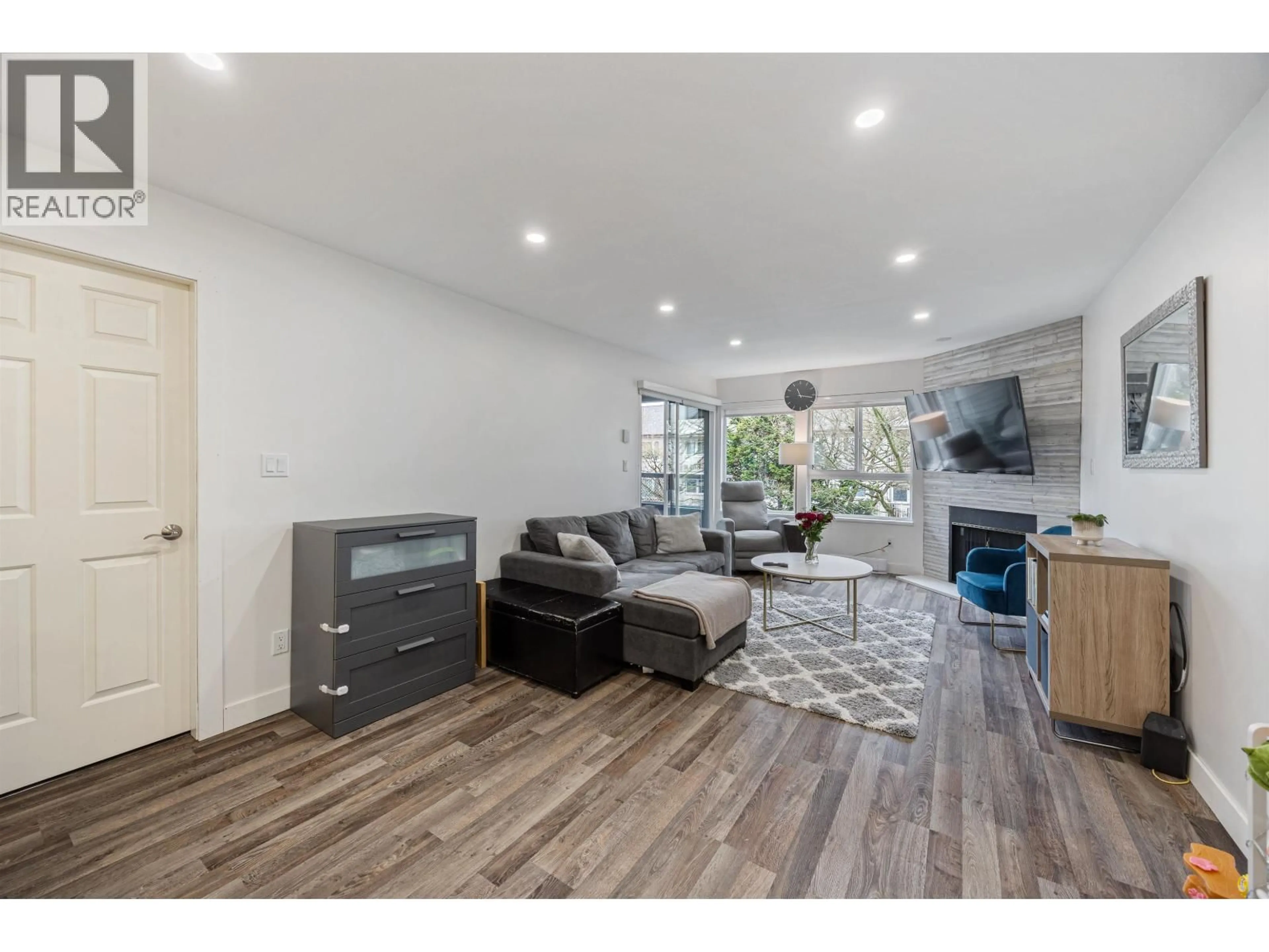 Living room with furniture, wood/laminate floor for 205 - 7465 SANDBORNE AVENUE, Burnaby British Columbia V3N4W7