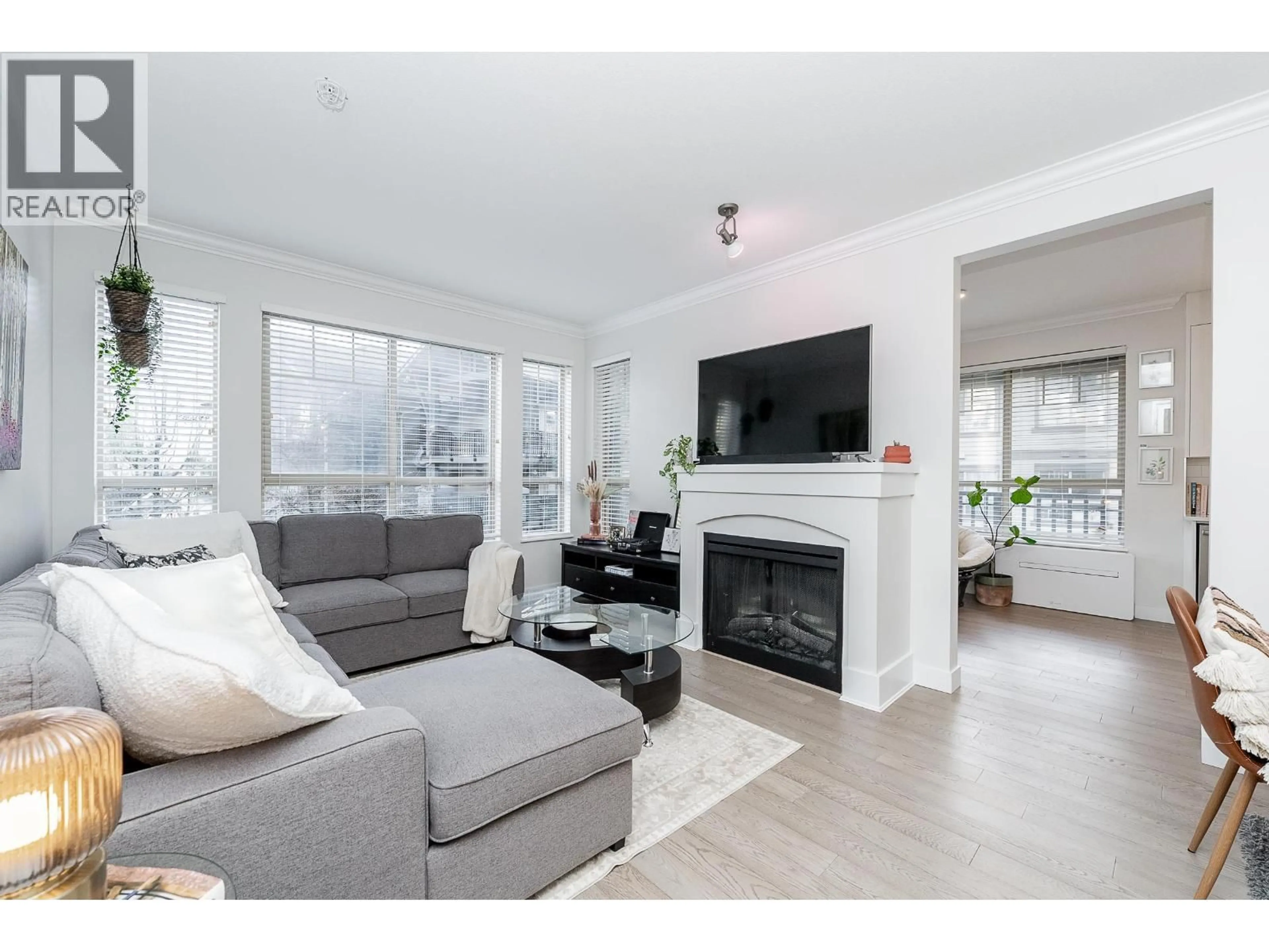 Living room with furniture, wood/laminate floor for 208 - 2969 WHISPER WAY, Coquitlam British Columbia V3E3S8