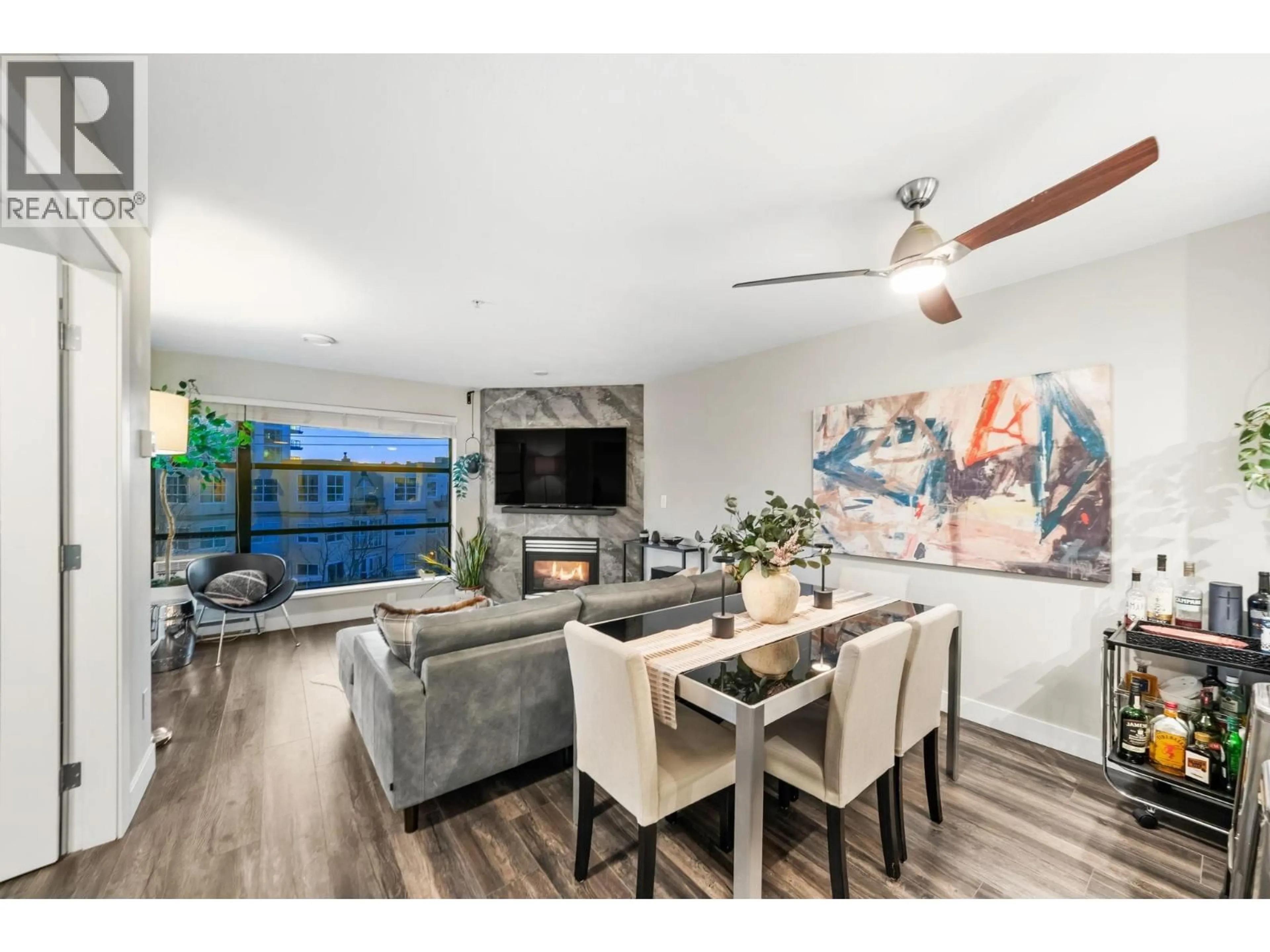 Living room with furniture, wood/laminate floor for 410 - 124 3RD STREET, North Vancouver British Columbia V7M1E8