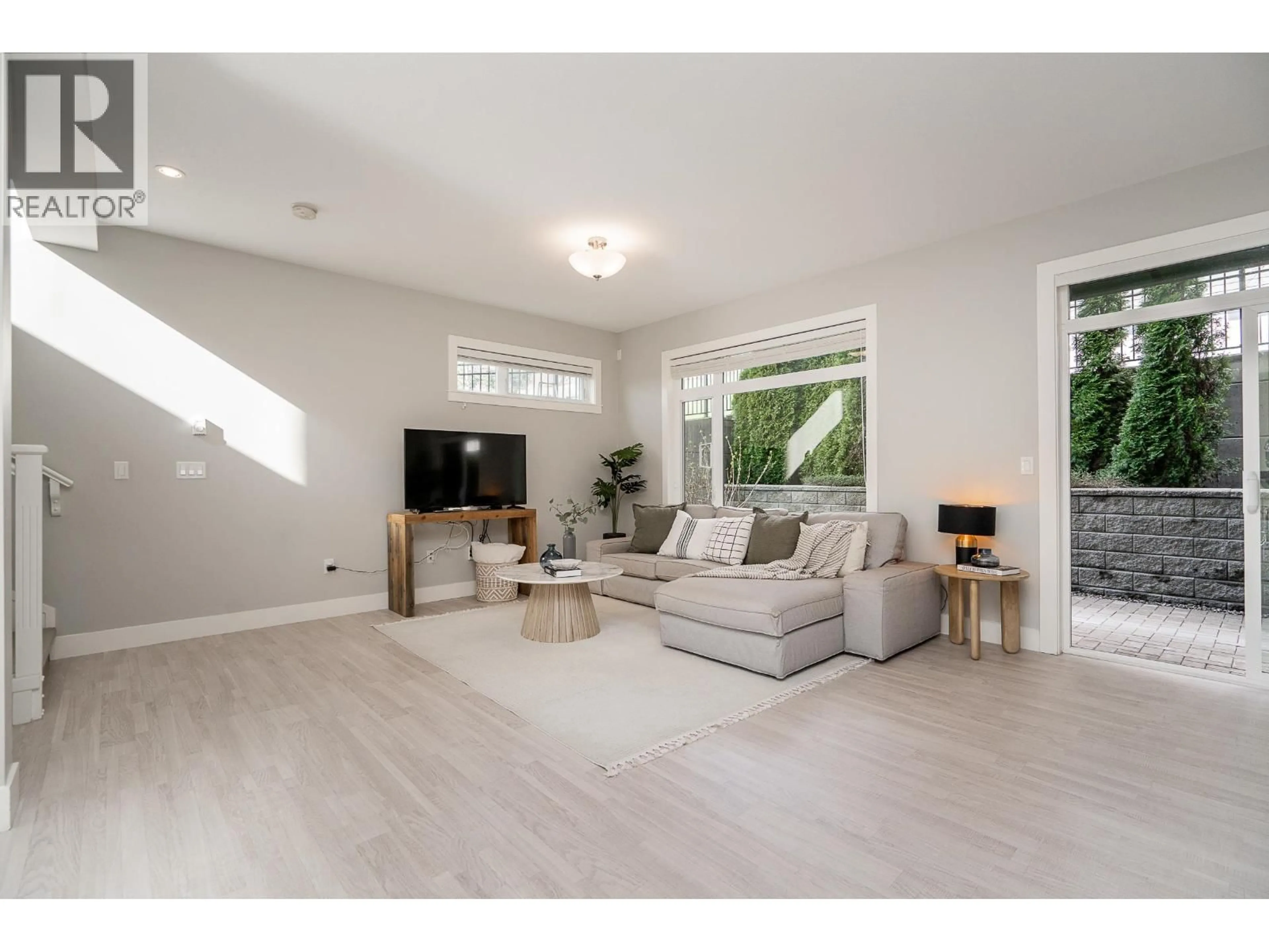 Living room with furniture, wood/laminate floor for 124 - 3525 CHANDLER STREET, Coquitlam British Columbia V3E0L9