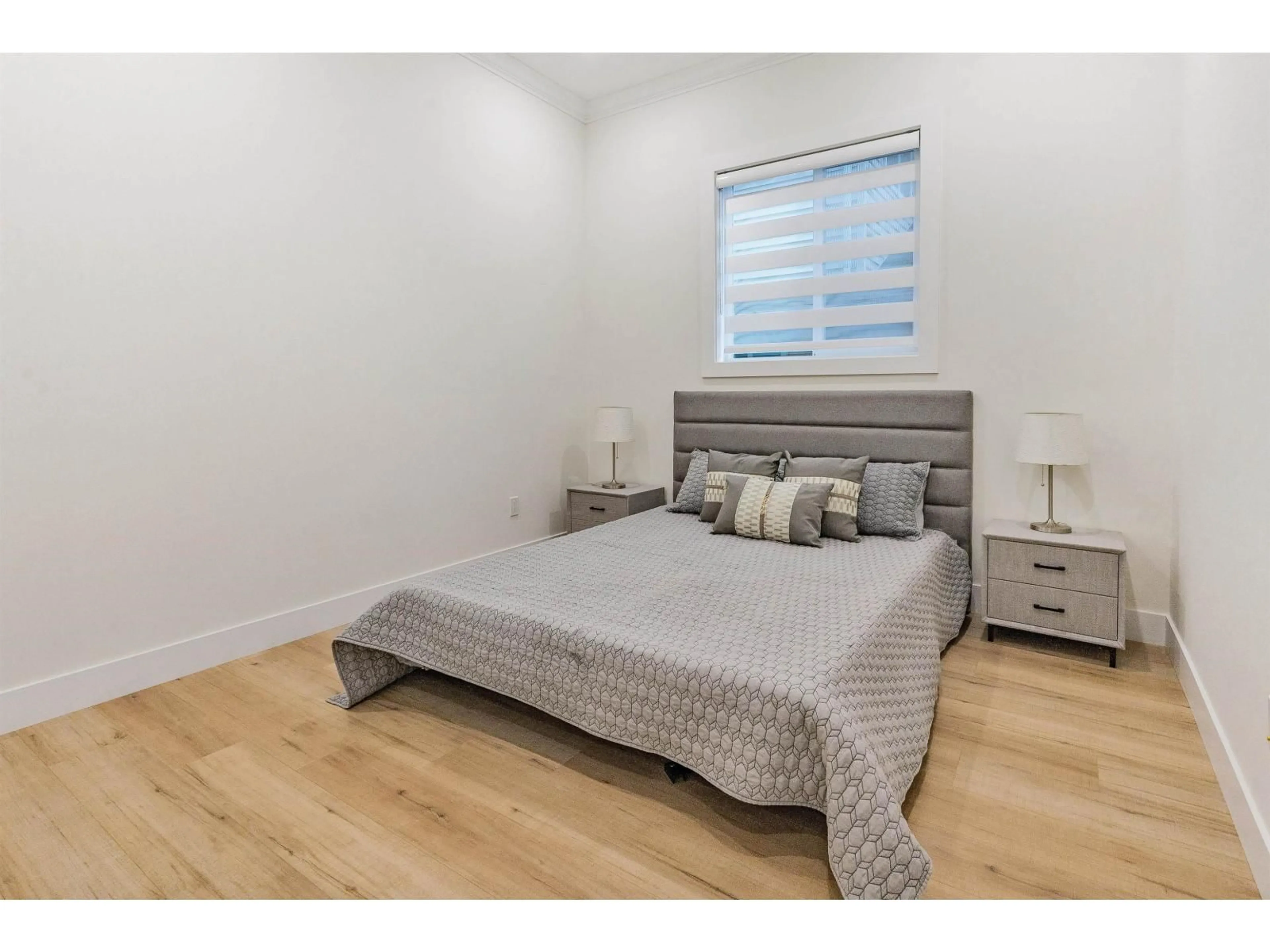 Bedroom with bed, wood/laminate floor for 11796 84 AVENUE, Delta British Columbia V4C2M5