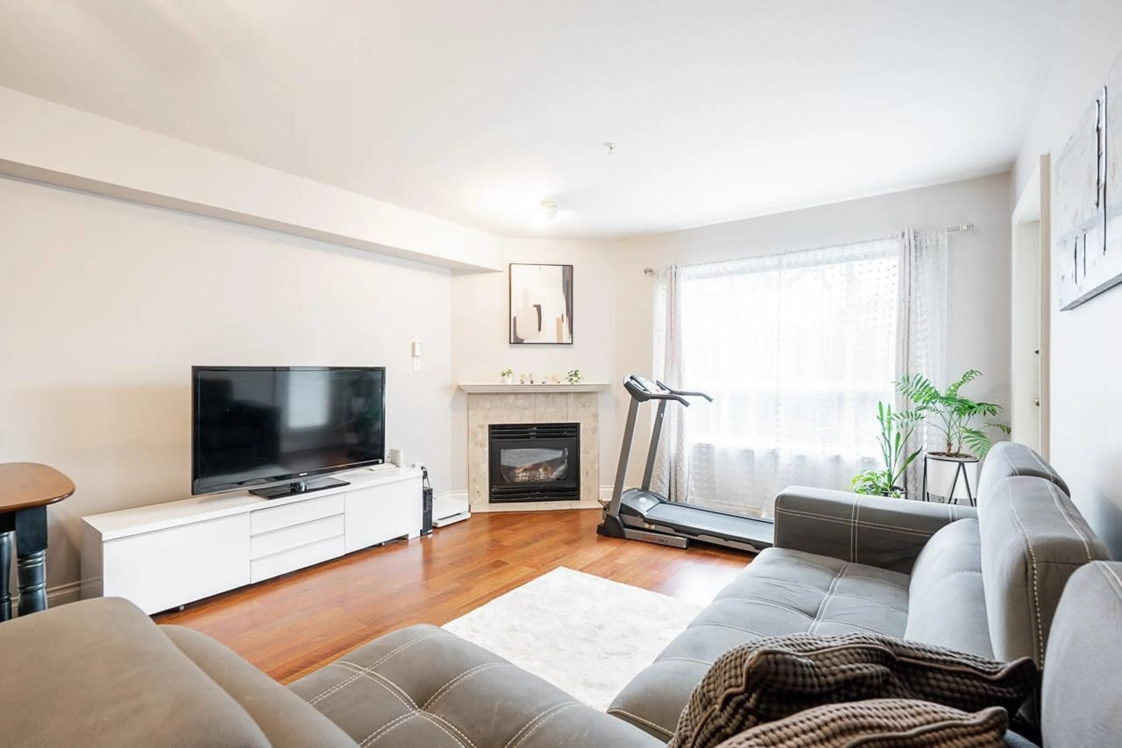 Living room with furniture, wood/laminate floor for 101 - 15885 84 AVENUE, Surrey British Columbia V4N0W7