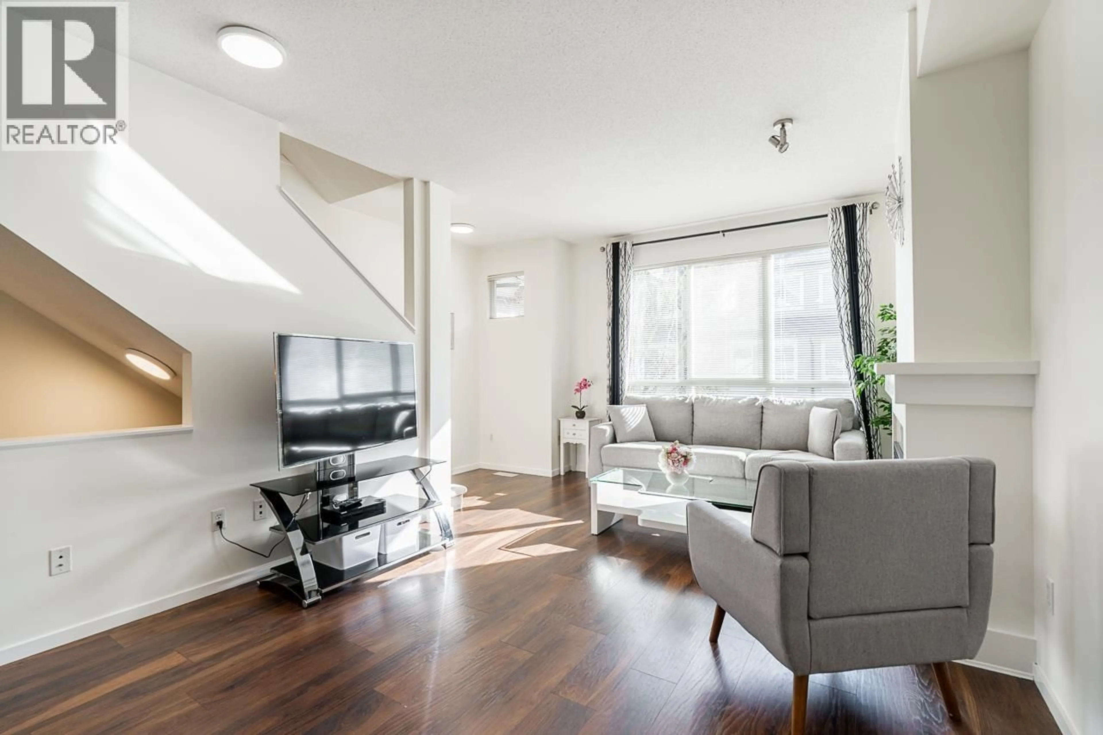 Living room with furniture, wood/laminate floor for 23 - 9088 HALSTON COURT, Burnaby British Columbia V3N0A7