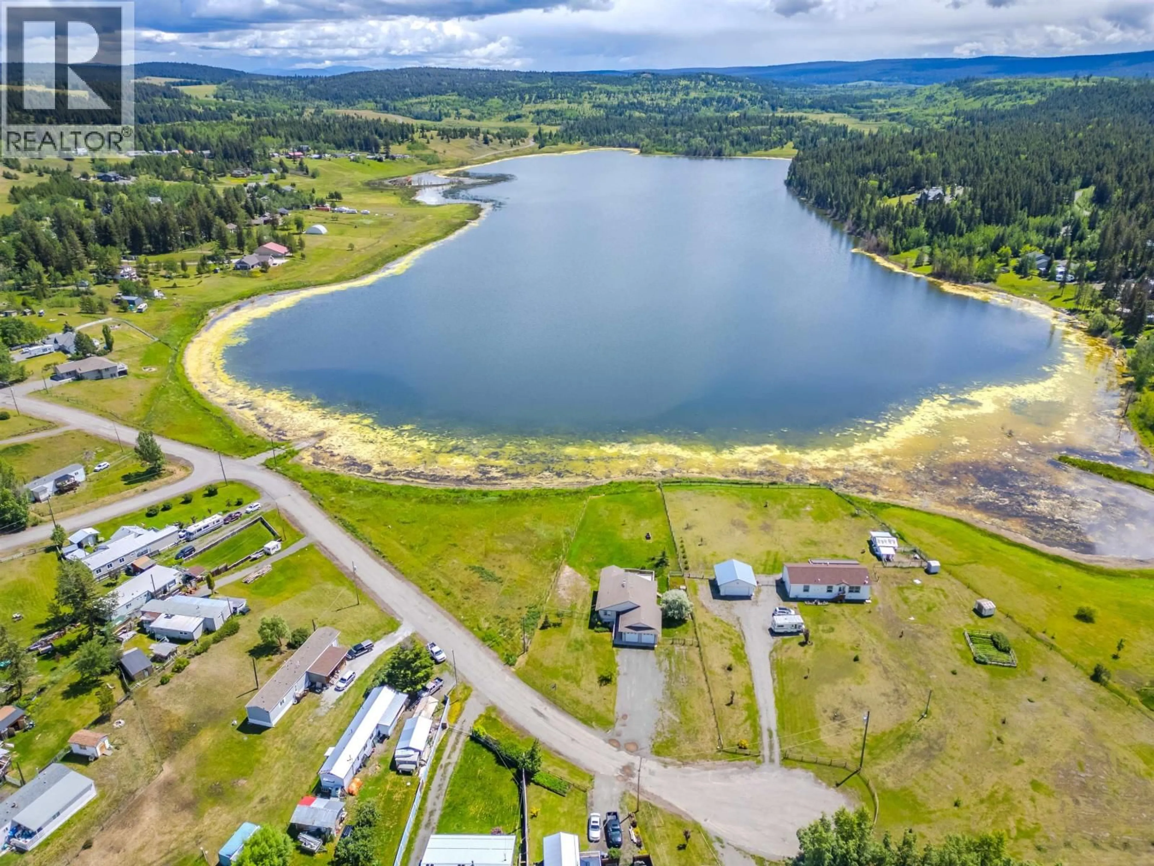 A pic from outside/outdoor area/front of a property/back of a property/a pic from drone, water/lake/river/ocean view for 5526 LAKESIDE COURT, 103 Mile House British Columbia V0K2E1