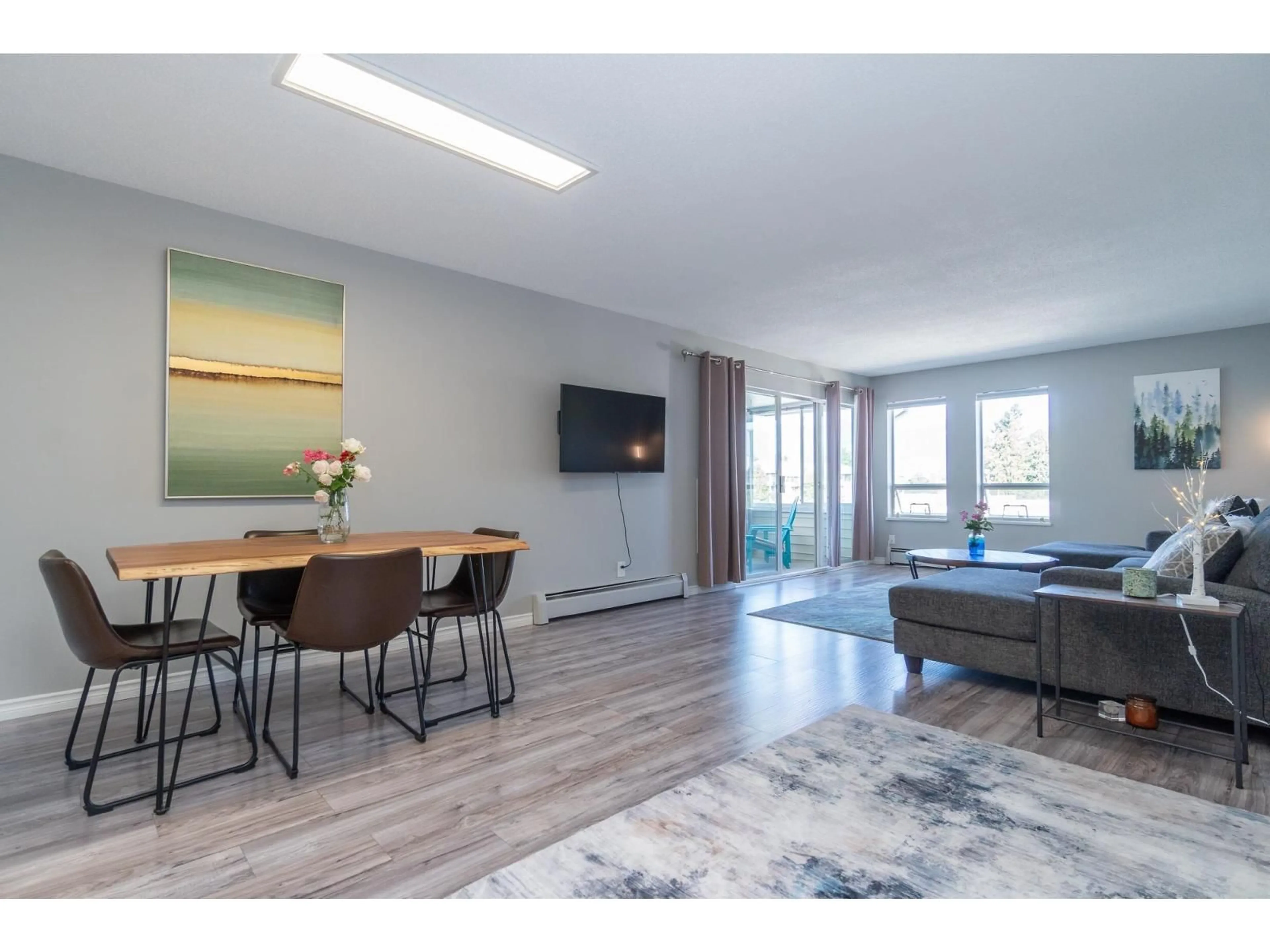 Living room with furniture, wood/laminate floor for 308 - 8725 ELM DRIVE, Chilliwack British Columbia V2P4Y3