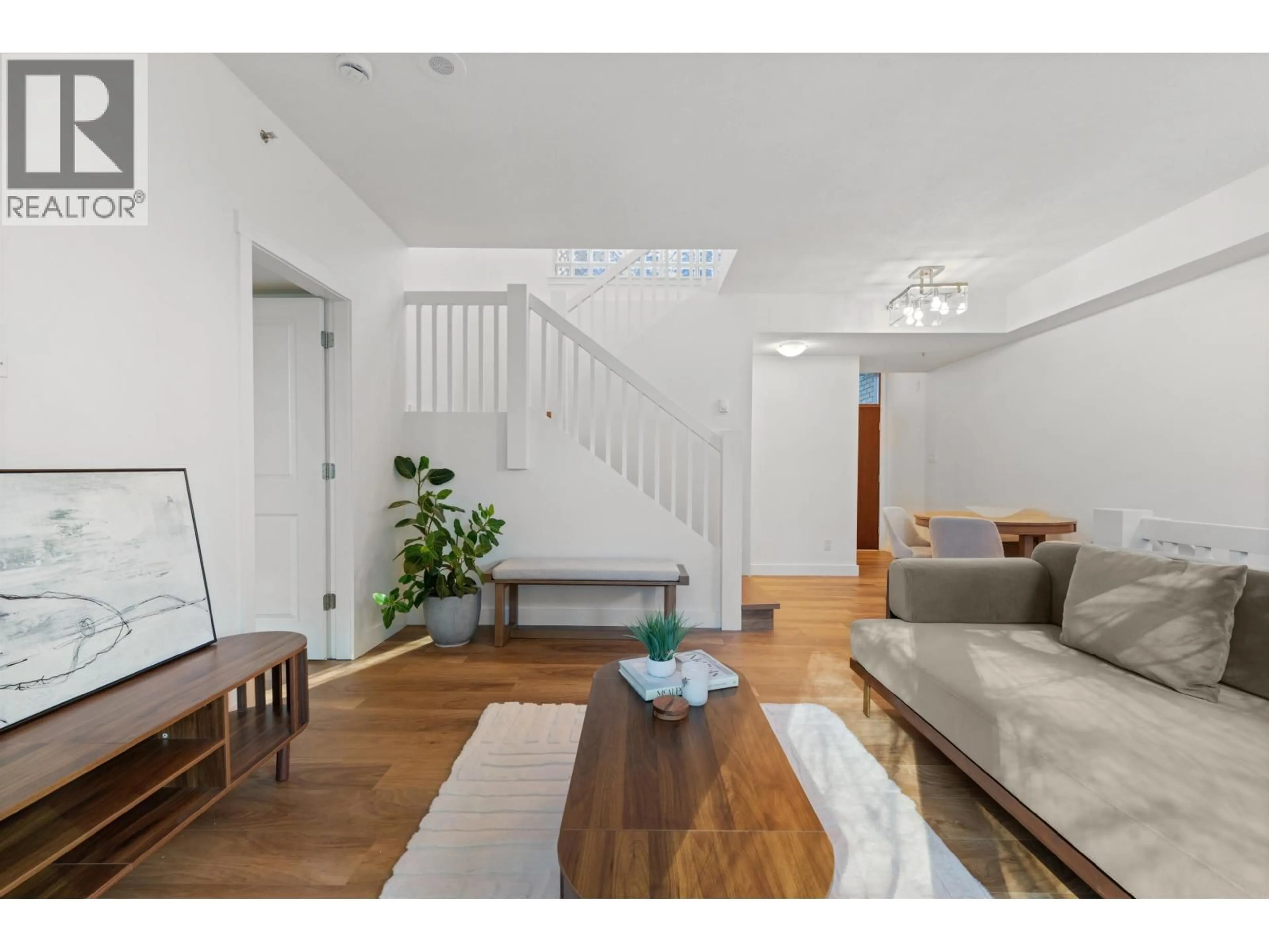 Living room with furniture, wood/laminate floor for 203 - 1238 MELVILLE STREET, Vancouver British Columbia V6E4N2