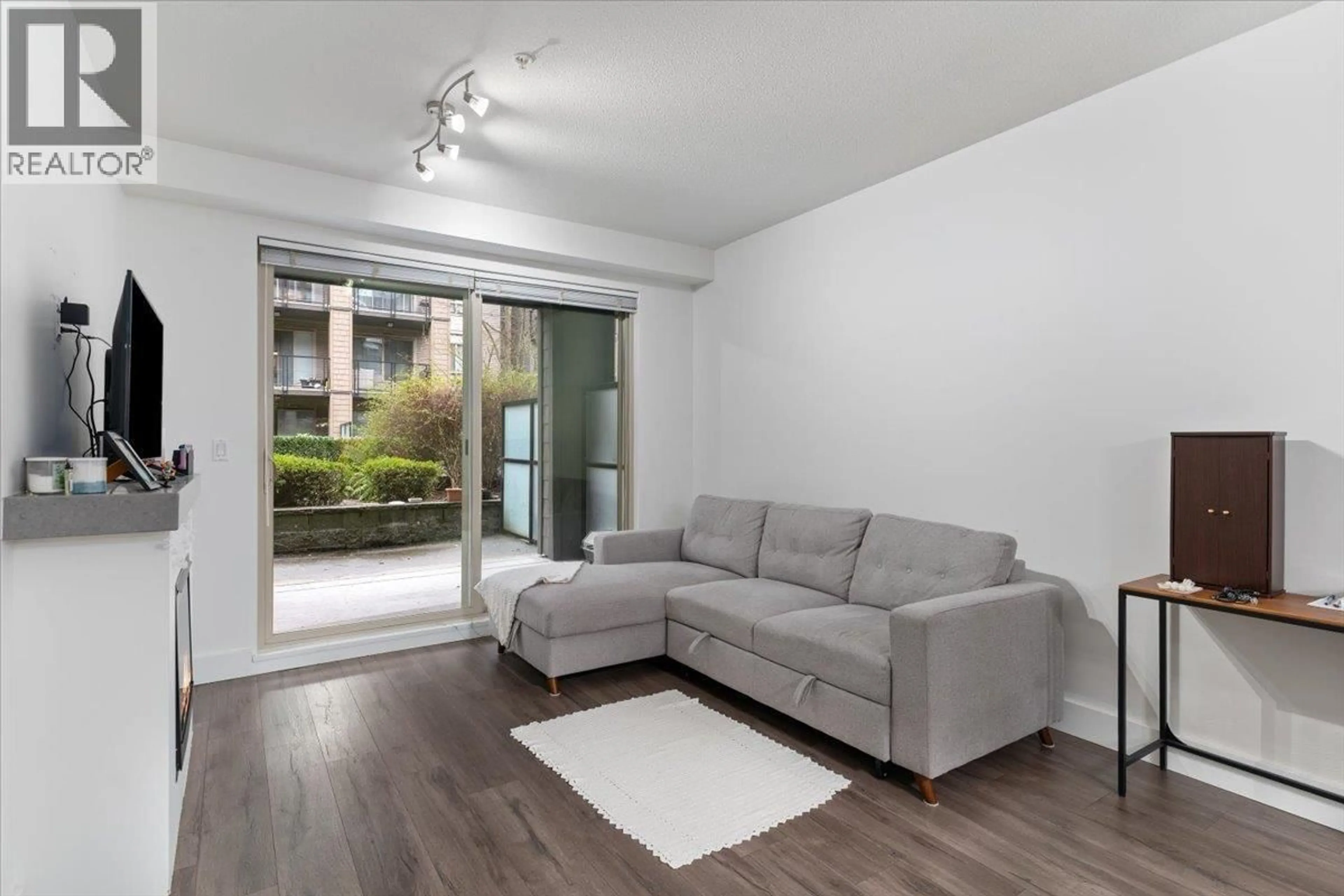 Living room with furniture, wood/laminate floor for 112 - 7478 BYRNEPARK WALK, Burnaby British Columbia V3N0B5