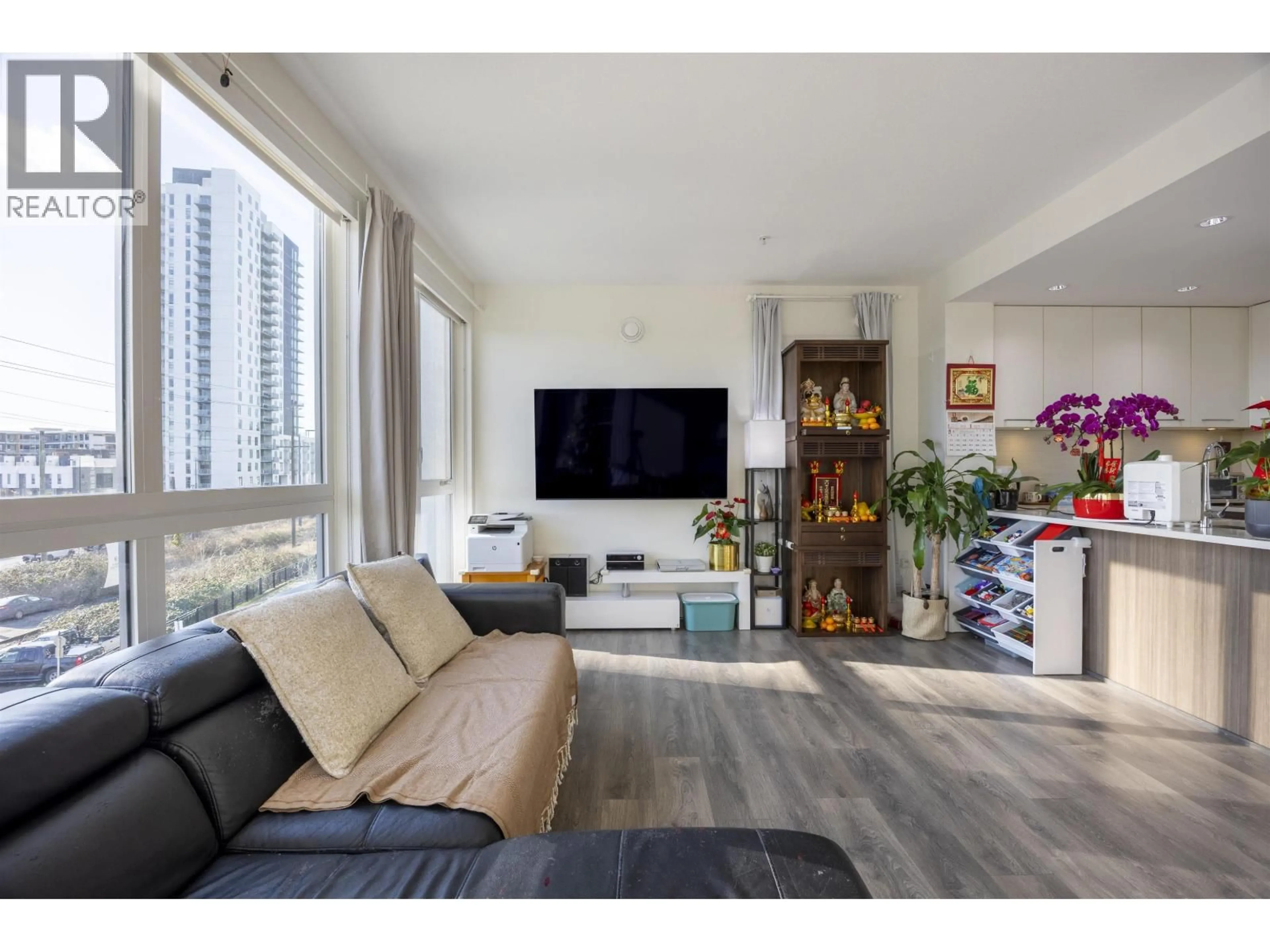 Living room with furniture, wood/laminate floor for 305 - 8580 RIVER DISTRICT CROSSING, Vancouver British Columbia V5S0B9