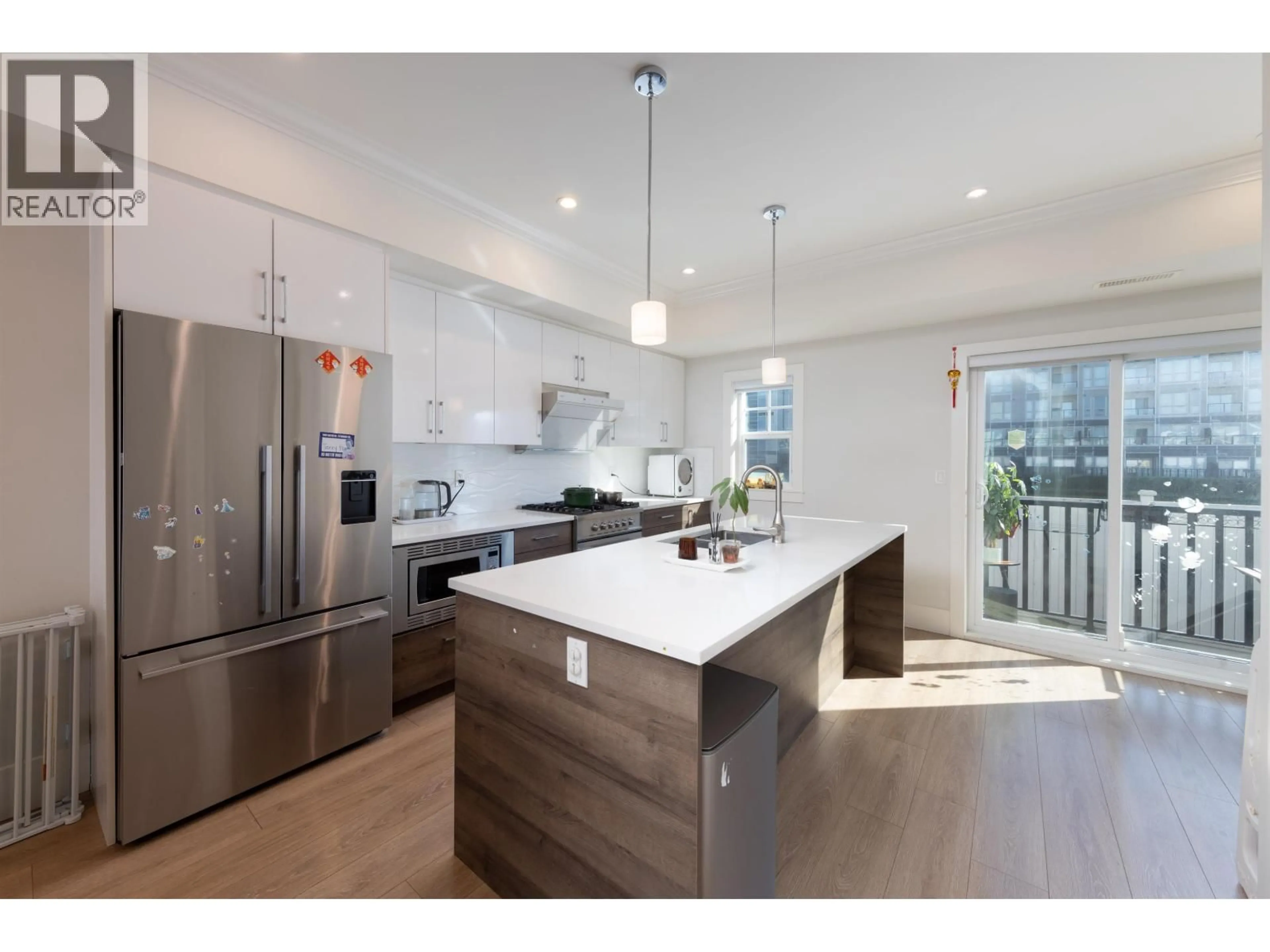 Open concept kitchen, wood/laminate floor for 9 - 9211 MCKIM WAY, Richmond British Columbia V6X0T1