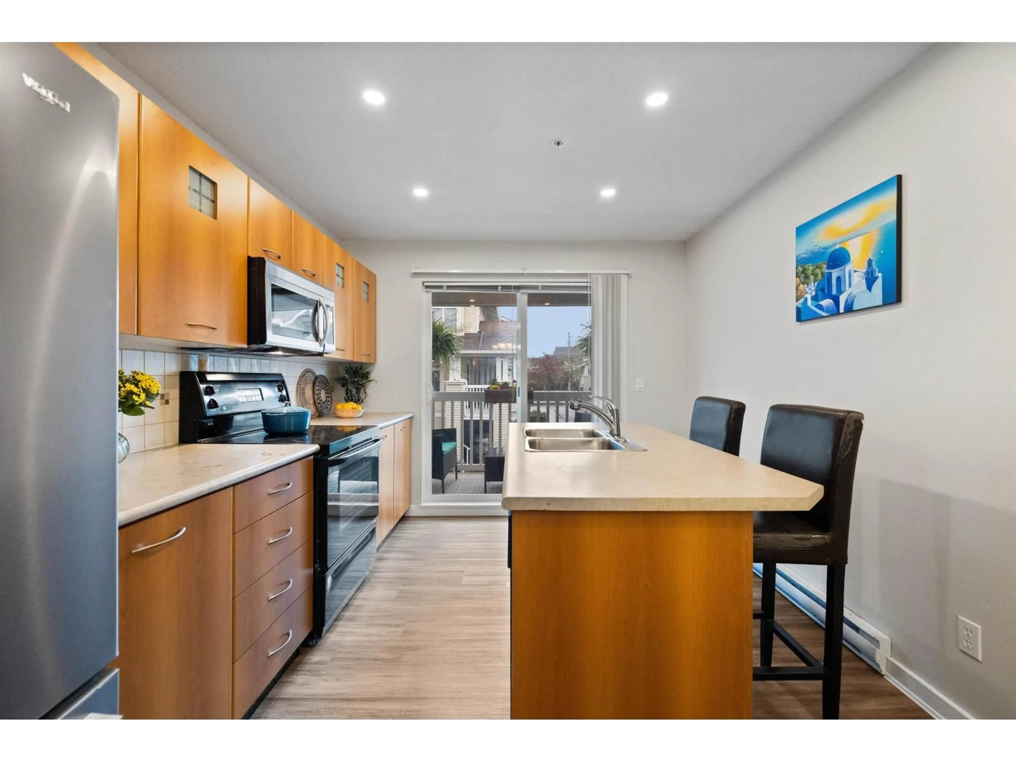 Open concept kitchen, wood/laminate floor for 61 - 7179 201 STREET, Langley British Columbia V2Y2Y9