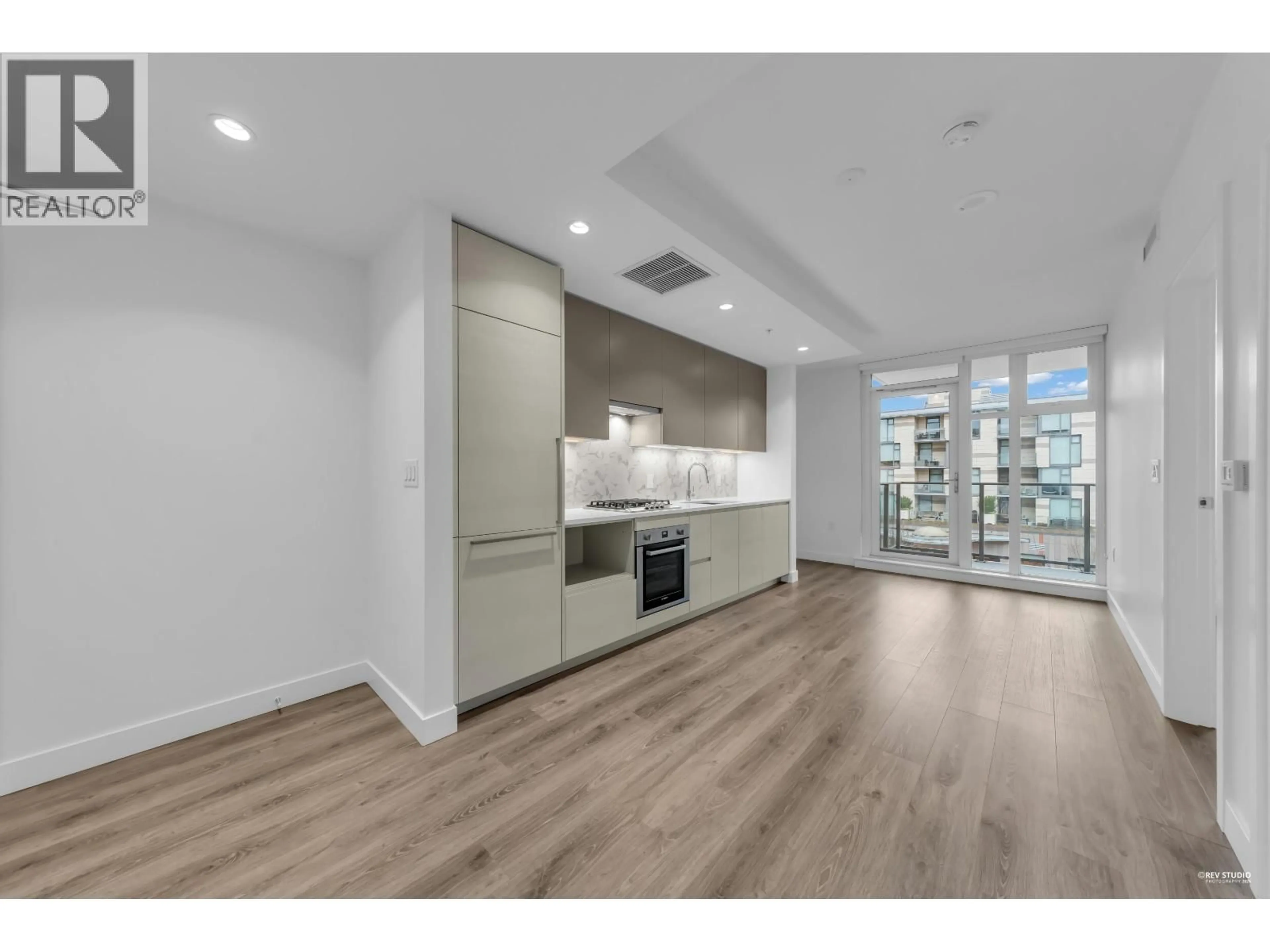 Open concept kitchen, wood/laminate floor for 303 - 8121 CHESTER STREET, Vancouver British Columbia V5X0J9