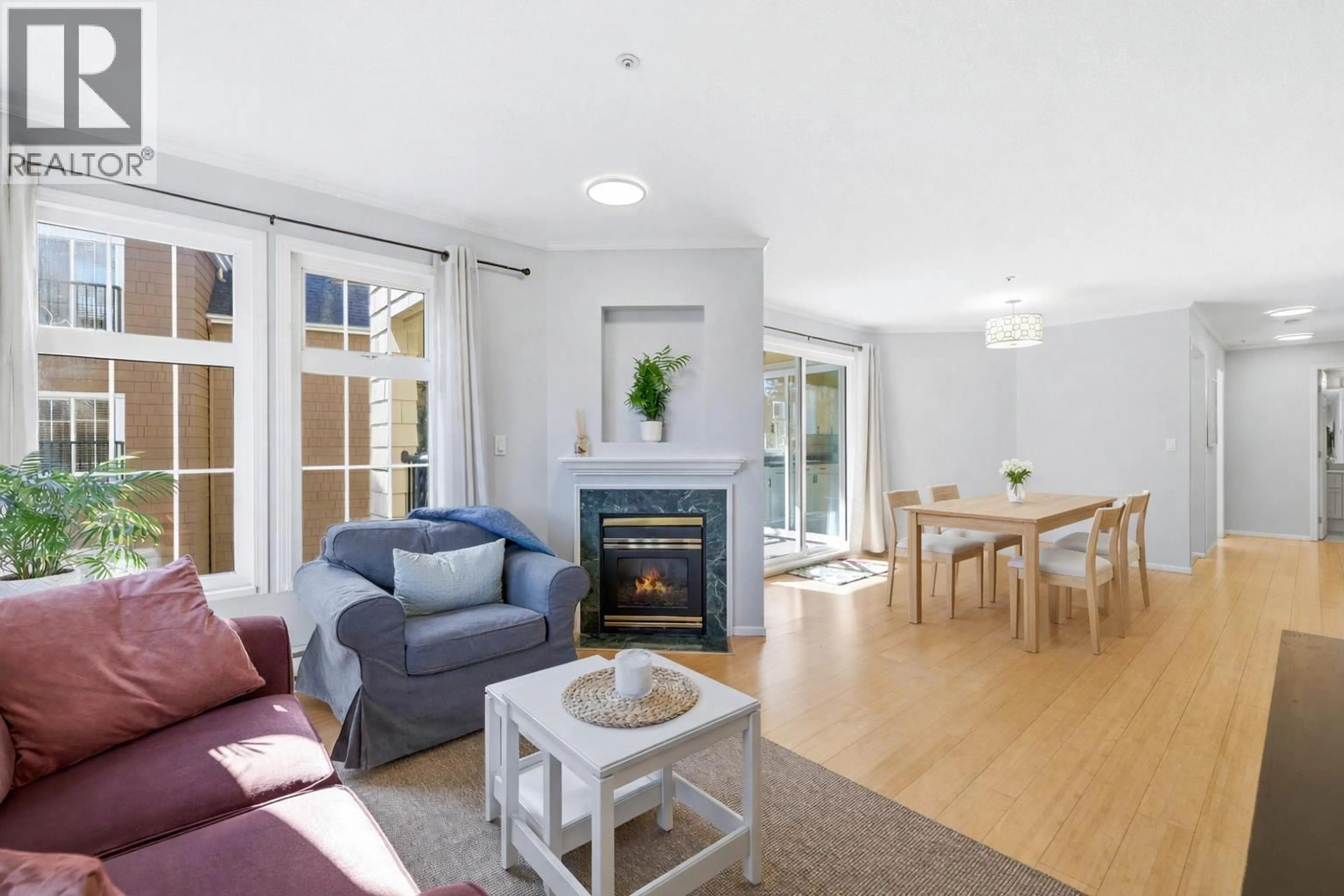 Living room with furniture, wood/laminate floor for 206 - 5556 14 AVENUE, Delta British Columbia V4M4E7