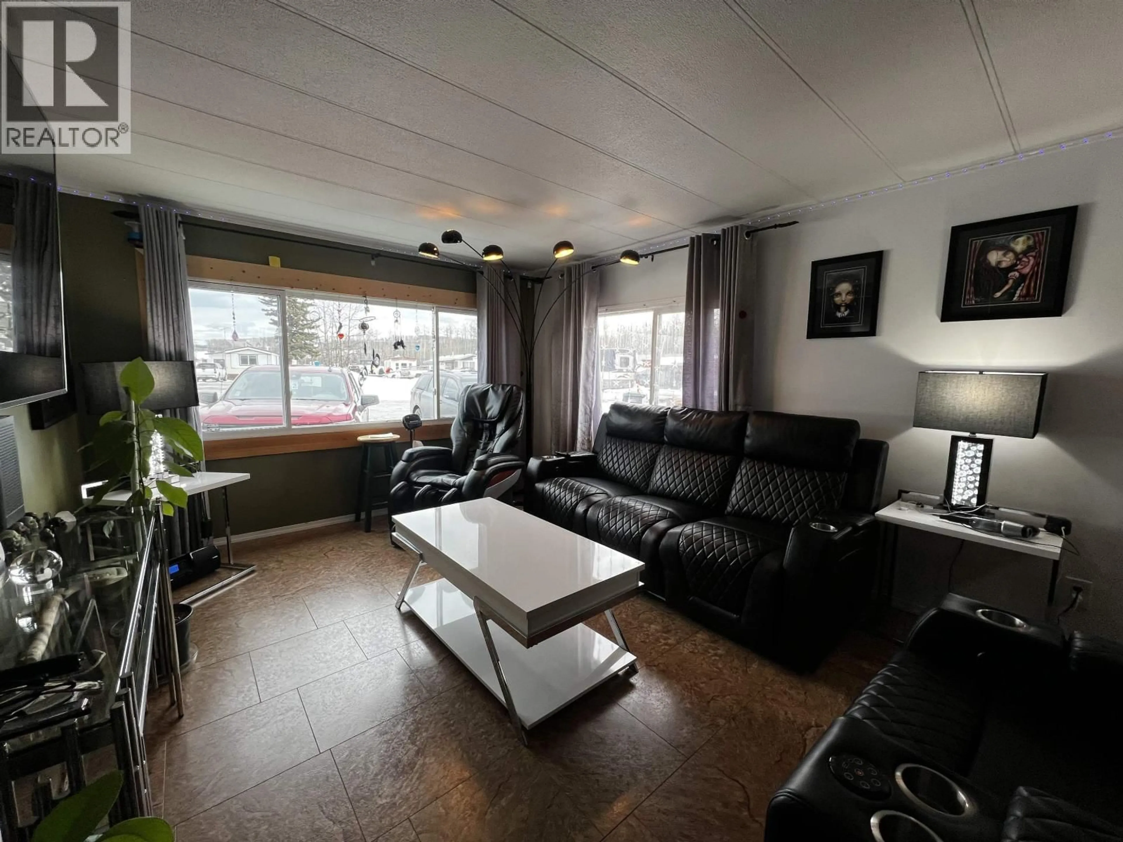 Living room with furniture, wood/laminate floor for 30 - 44 ENDAKO AVENUE, Fraser Lake British Columbia V0J1S0