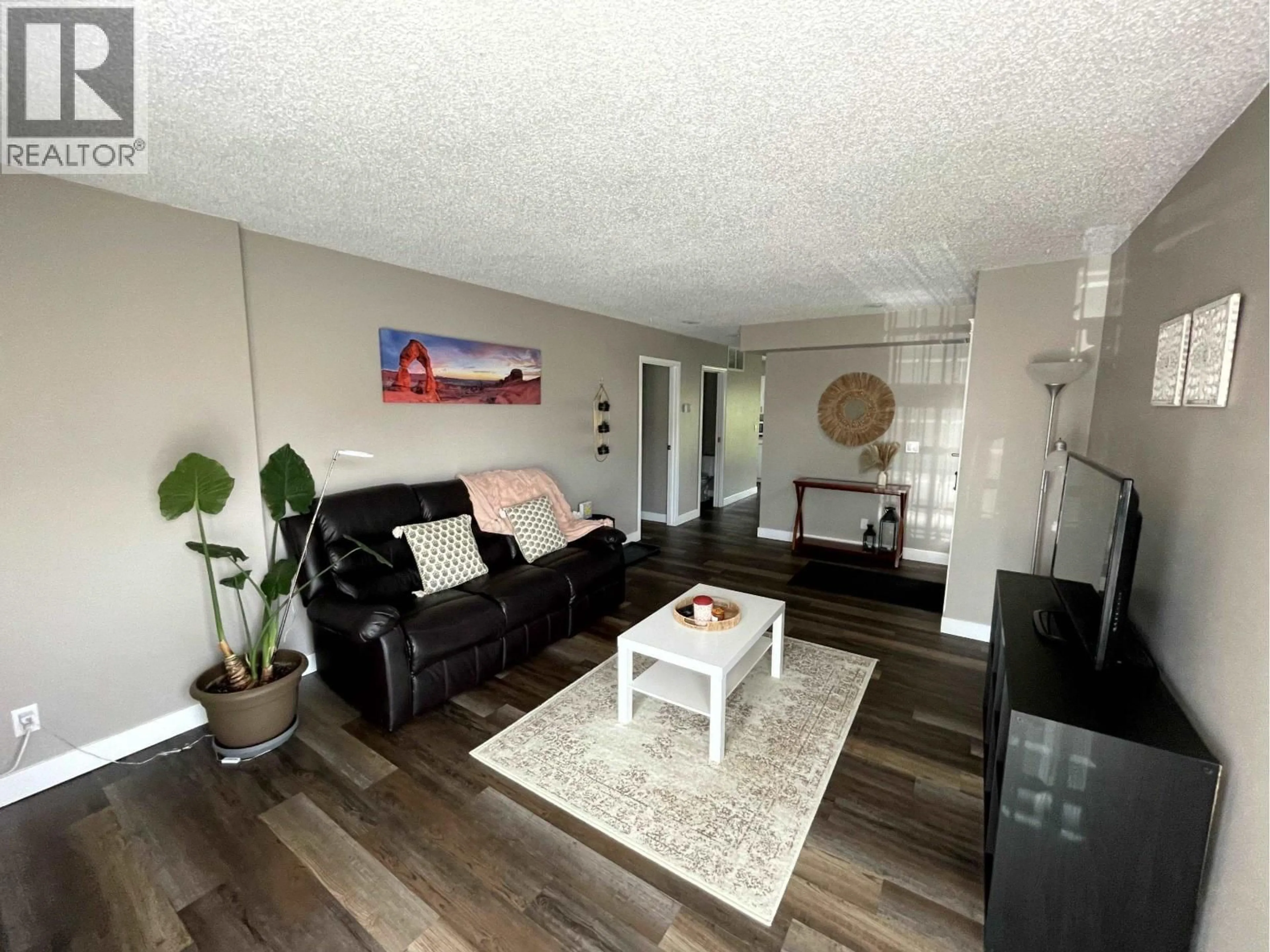 Living room with furniture, wood/laminate floor for 9102 112 AVENUE, Fort St. John British Columbia V1J5H8