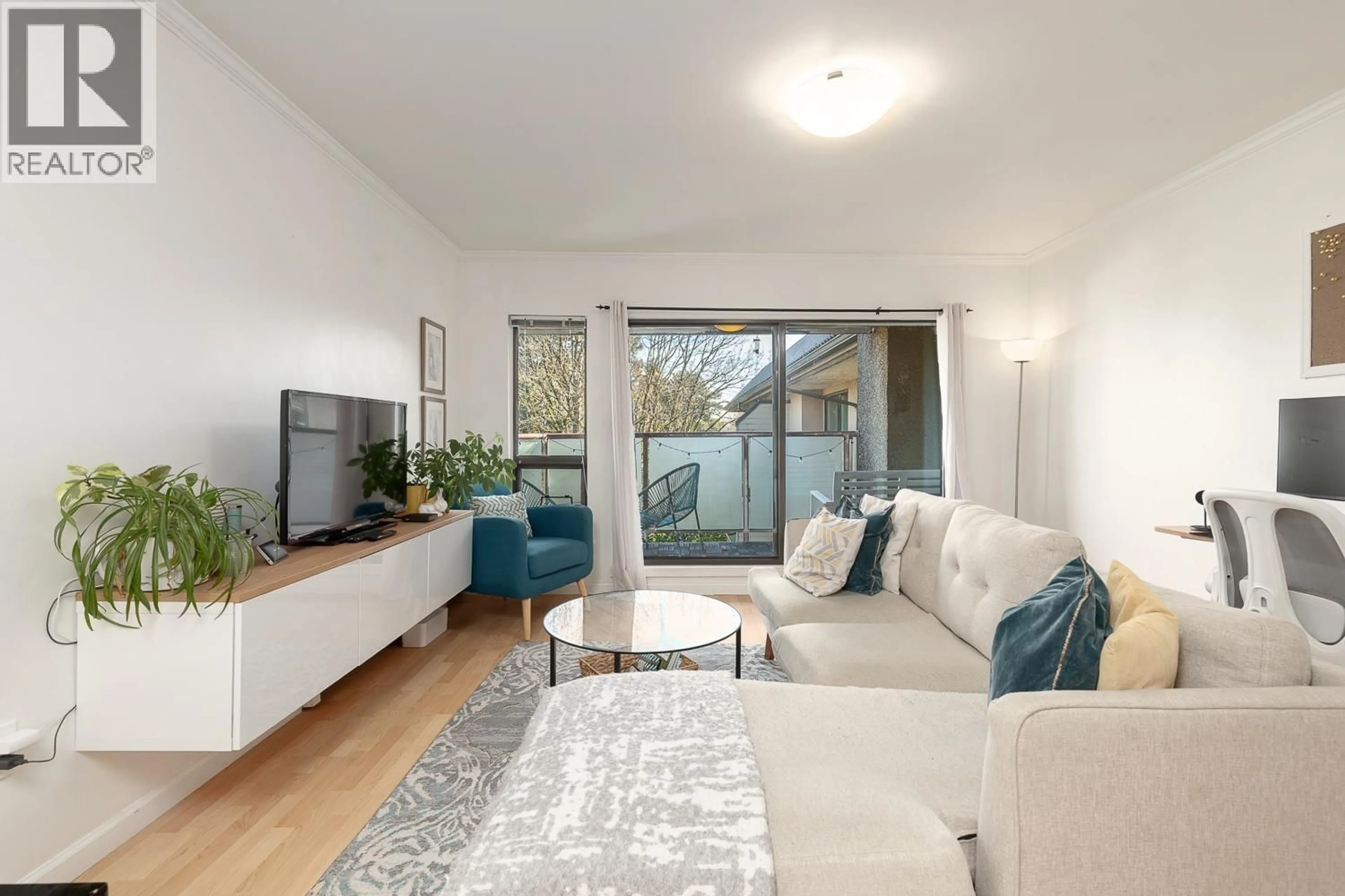 Living room with furniture, wood/laminate floor for 309 - 2150 BRUNSWICK STREET, Vancouver British Columbia V5T3L5