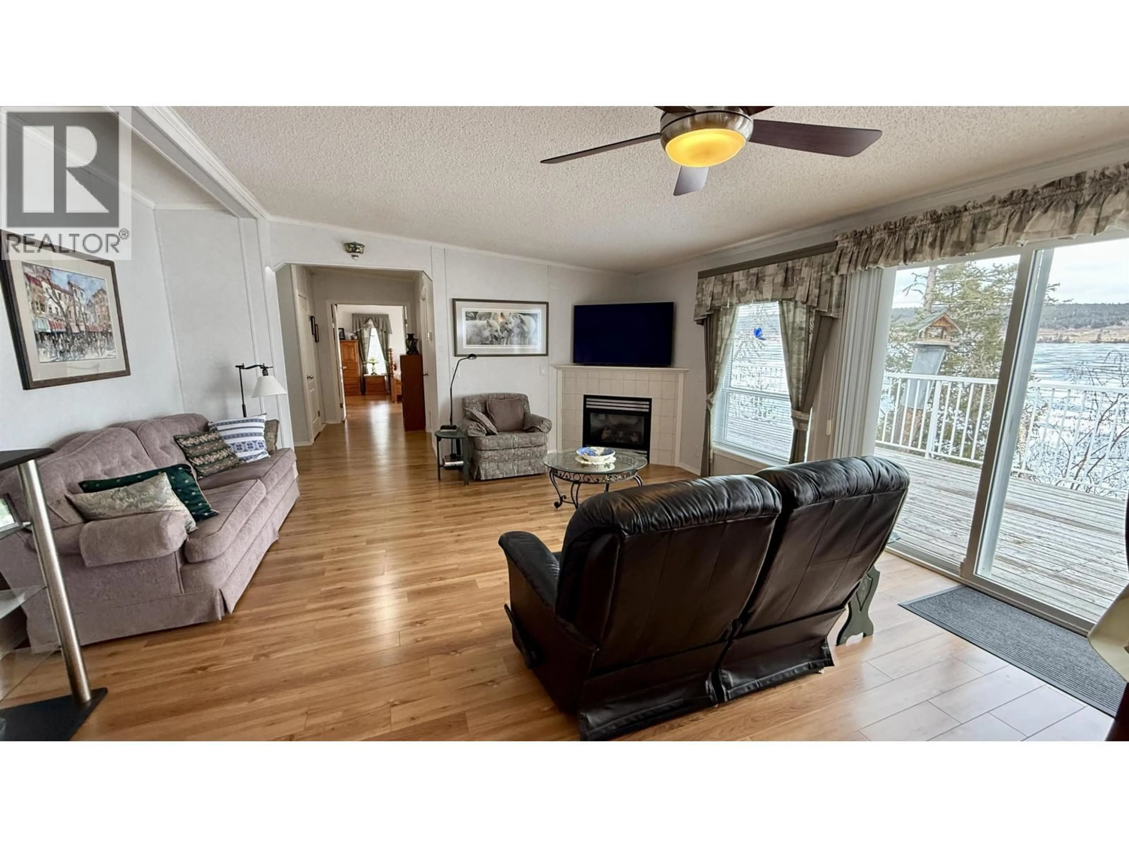 Living room with furniture, wood/laminate floor for 4574 CAVERLY ROAD, Lac La Hache British Columbia V0K1T0