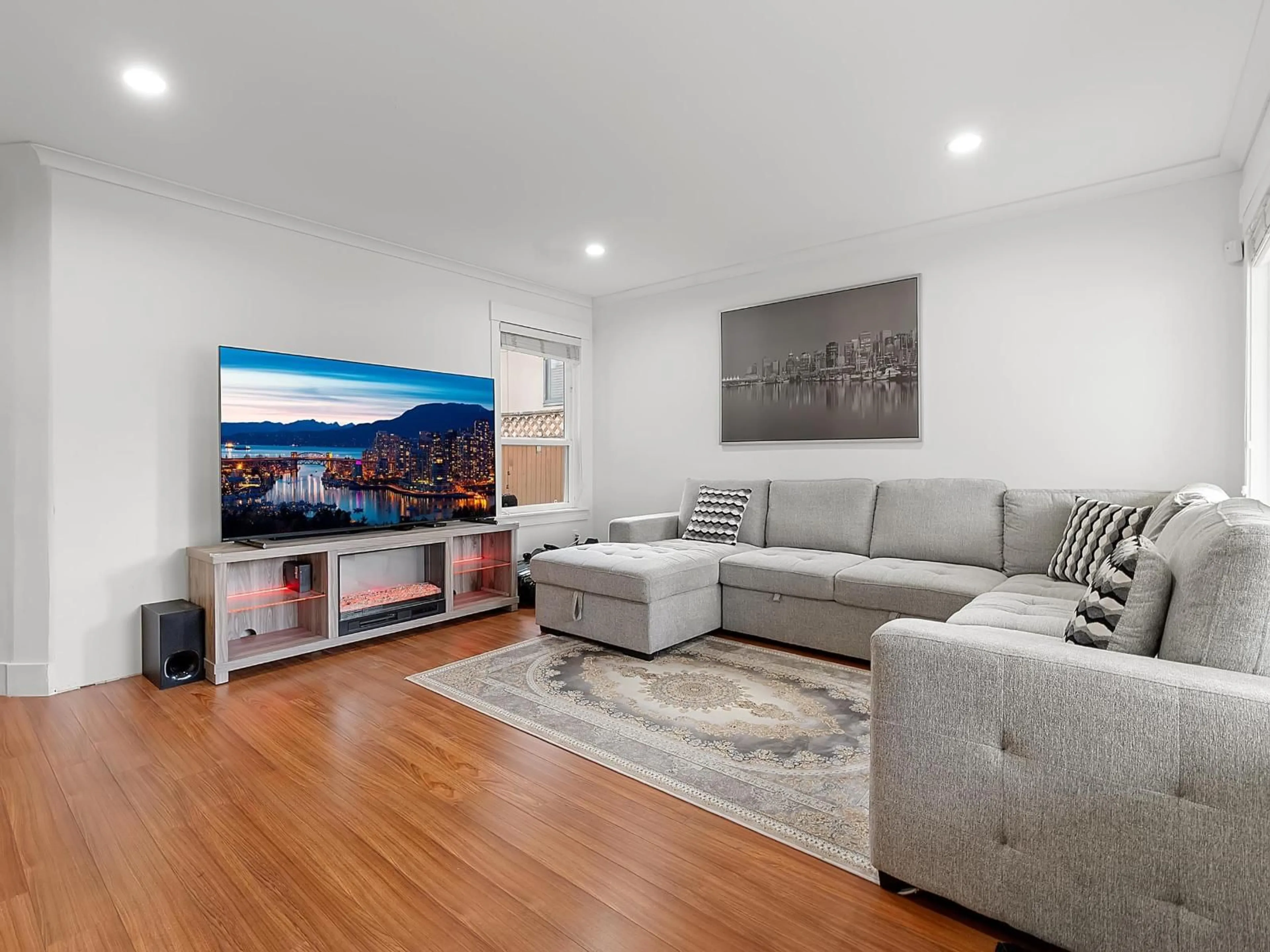 Living room with furniture, wood/laminate floor for 7908 117 STREET, Delta British Columbia V4C6A5