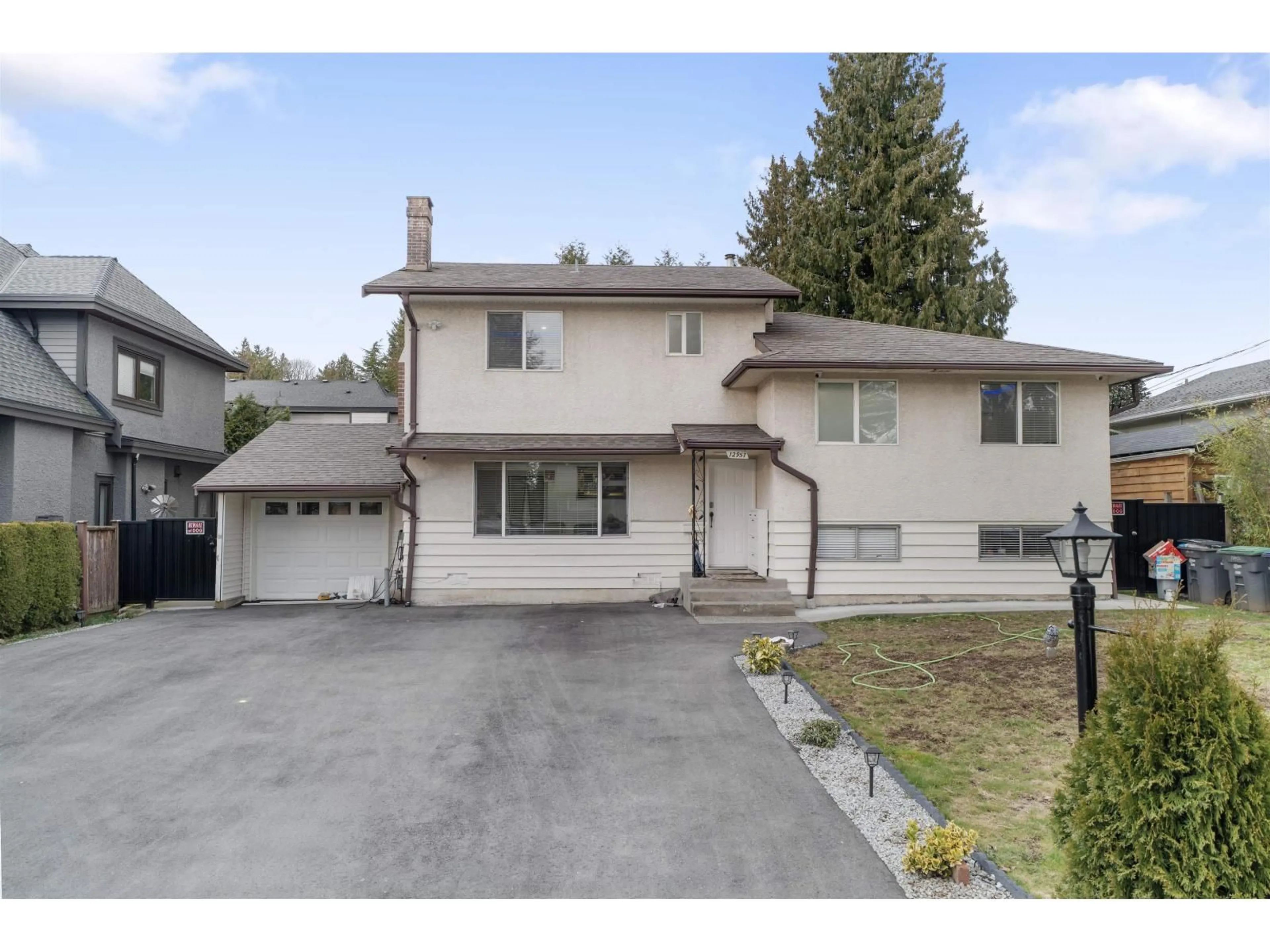 Home with vinyl exterior material, street for 12957 98B AVENUE, Surrey British Columbia V3T1C9