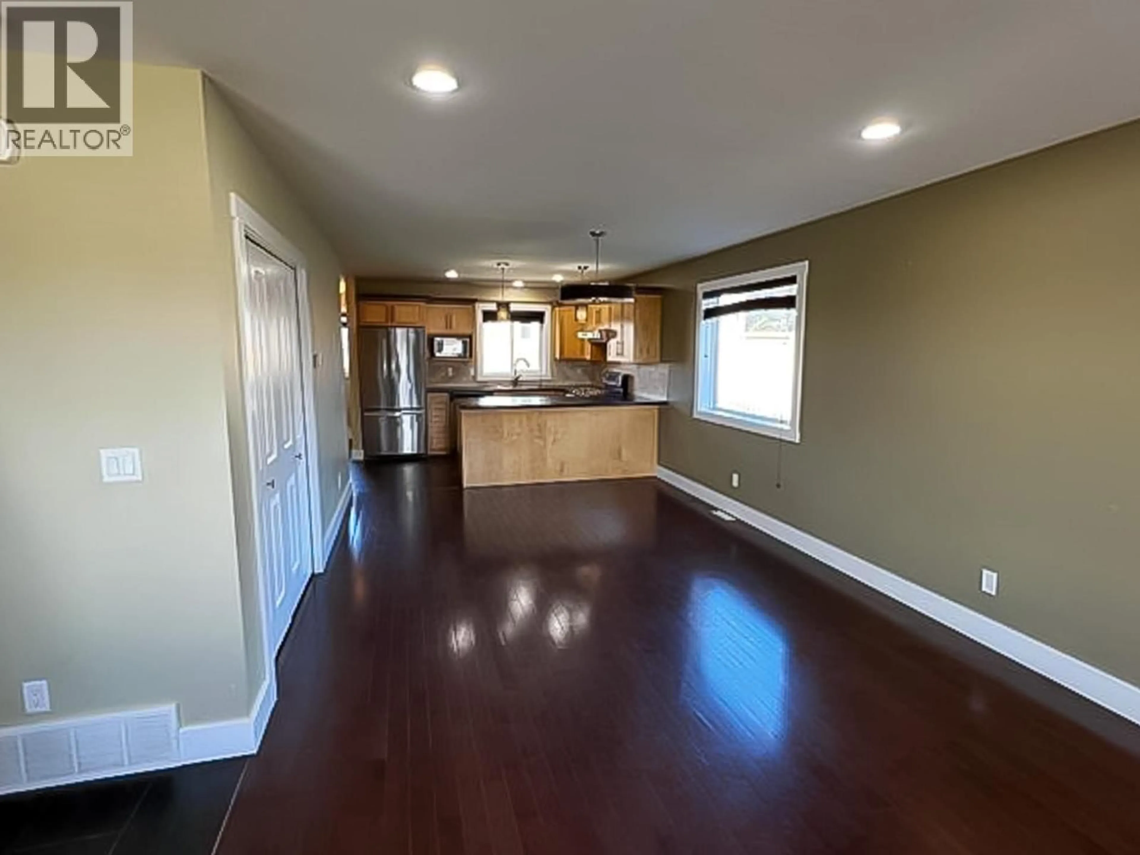 Open concept kitchen, wood/laminate floor for 8348 87 AVENUE, Fort St. John British Columbia V1J0K8