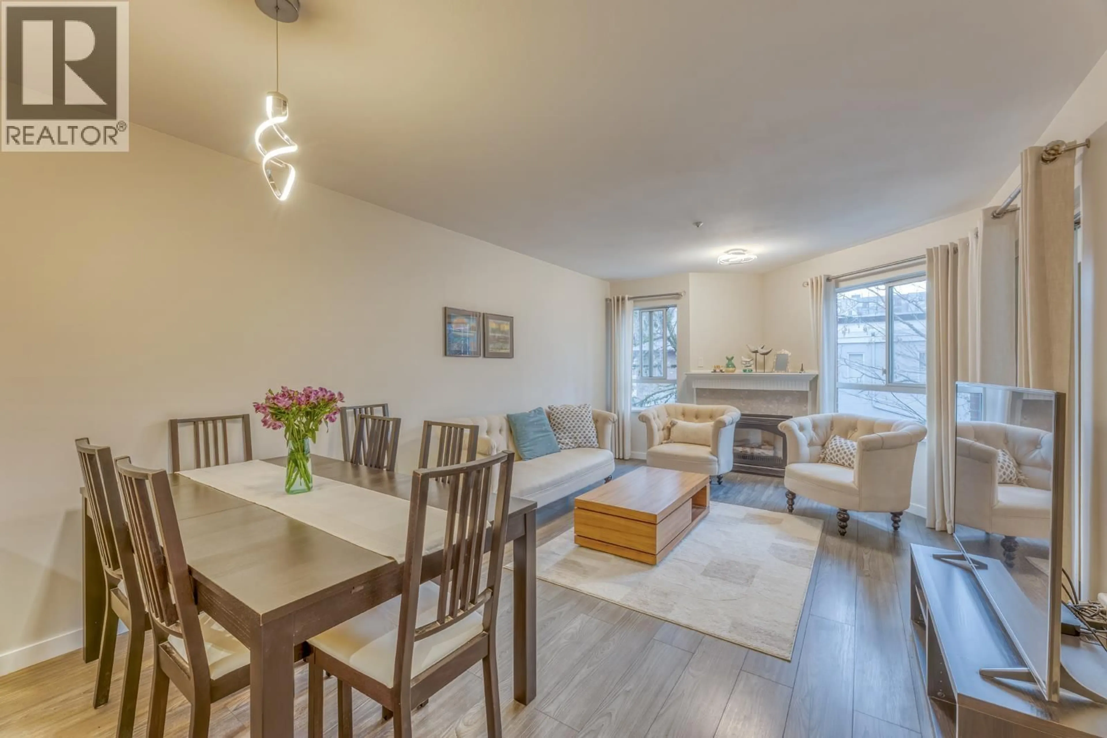 Living room with furniture, wood/laminate floor for 311 - 128 8TH STREET, North Vancouver British Columbia V7M3M1