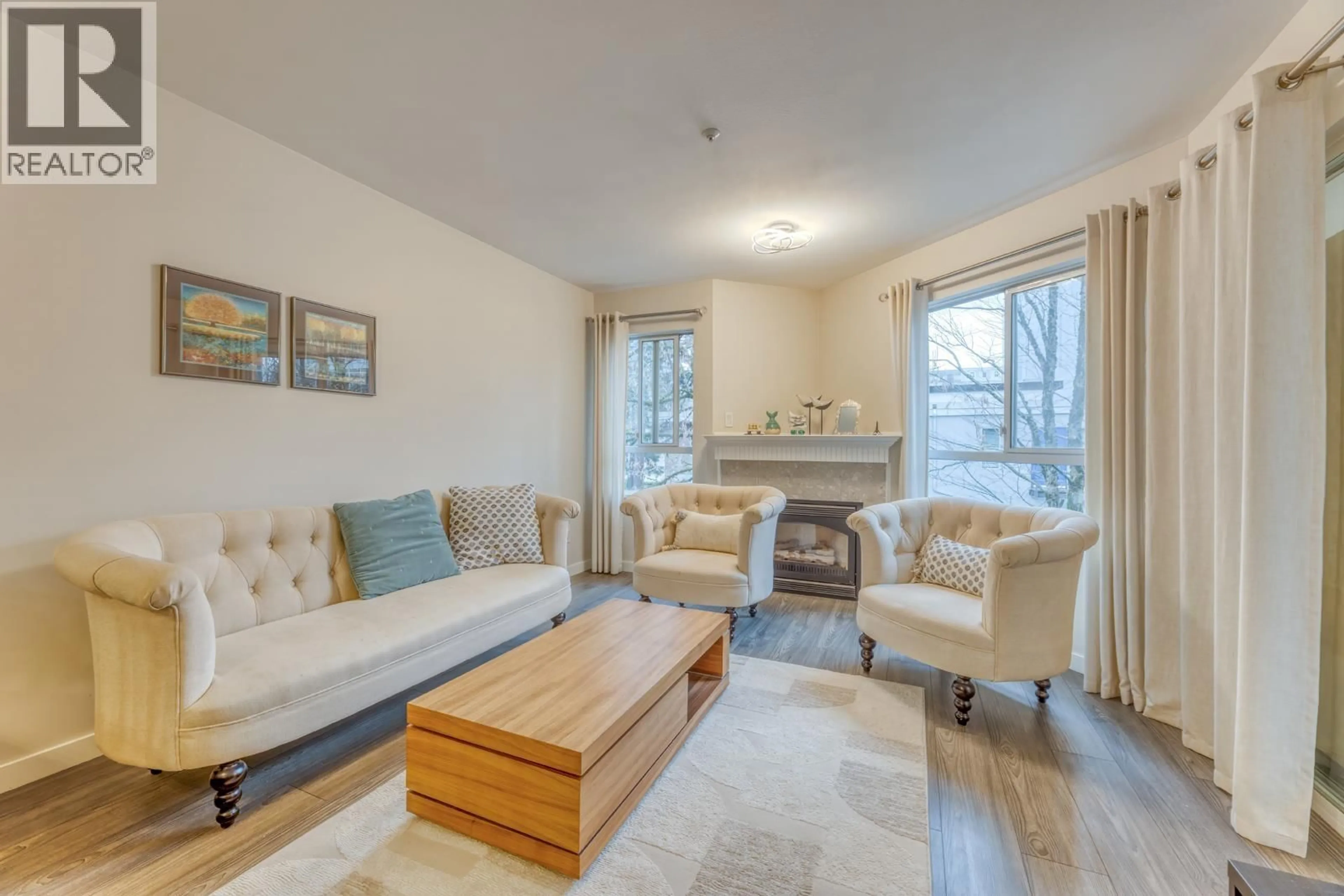 Living room with furniture, wood/laminate floor for 311 - 128 8TH STREET, North Vancouver British Columbia V7M3M1