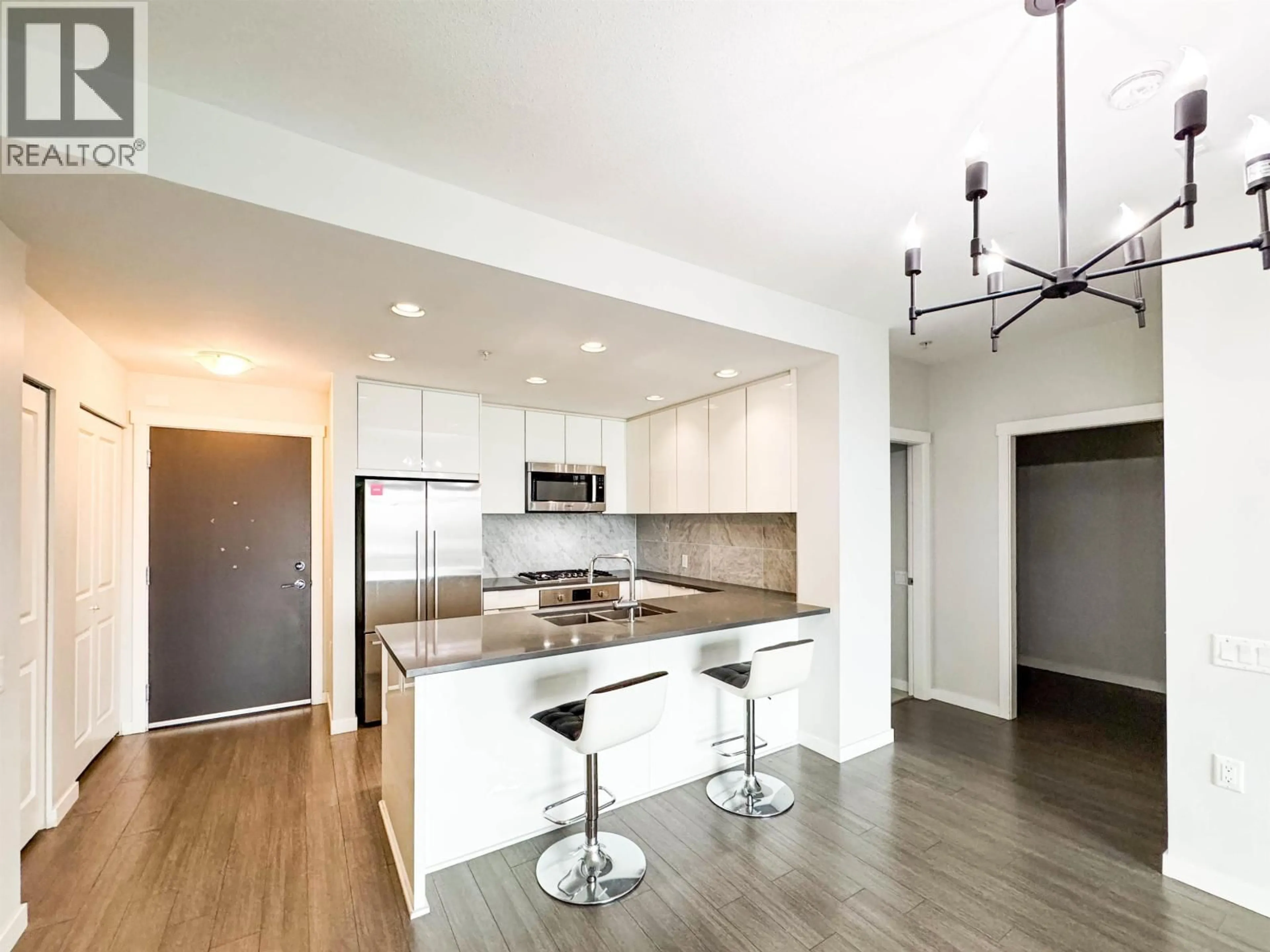 Open concept kitchen, wood/laminate floor for 404 - 3289 RIVERWALK AVENUE, Vancouver British Columbia V5S0G2