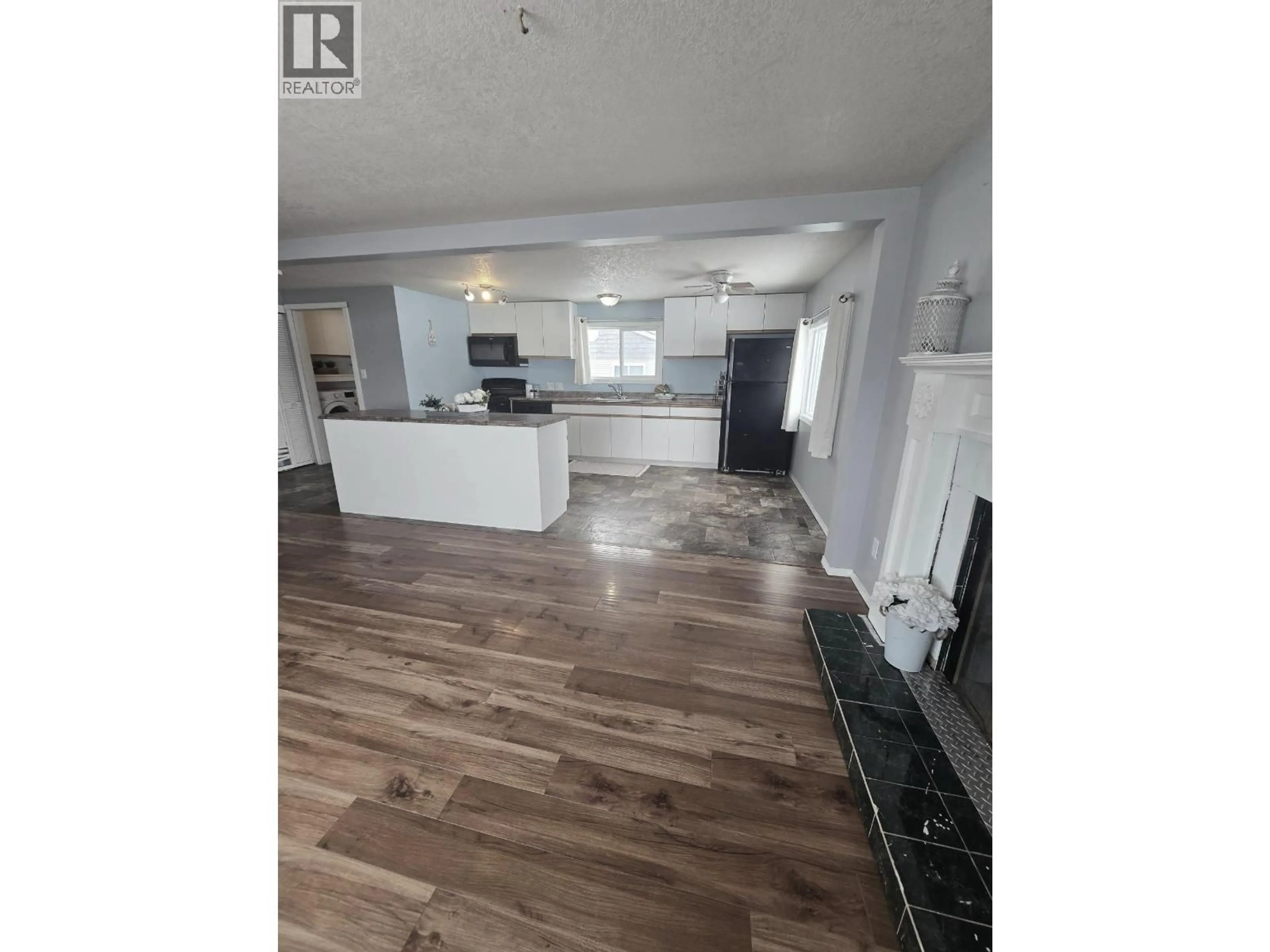 Open concept kitchen, wood/laminate floor for 9223 77 STREET, Fort St. John British Columbia V1J3A8
