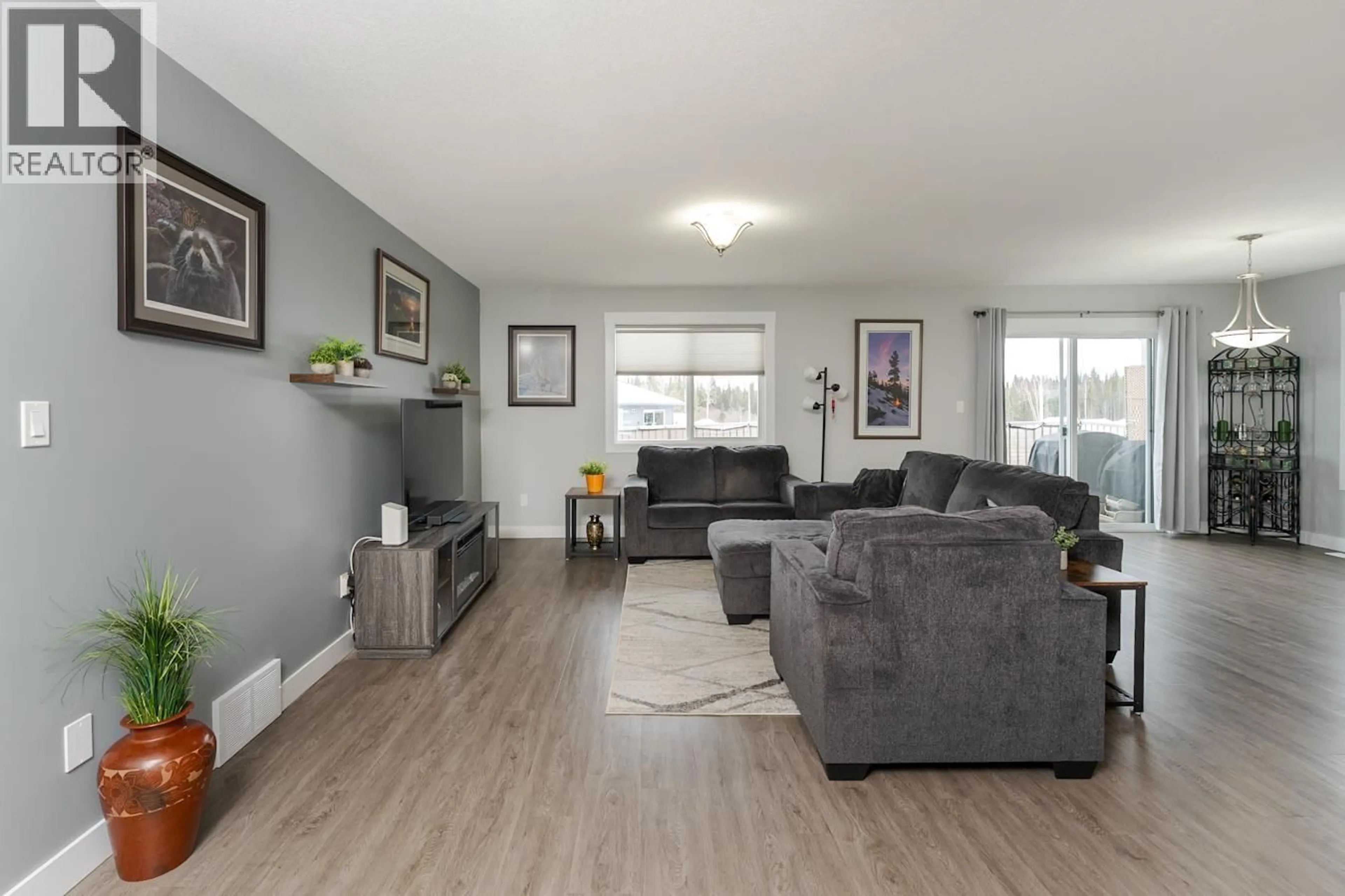 Living room with furniture, wood/laminate floor for 9060 TATLOW PLACE, Prince George British Columbia V2K0B5