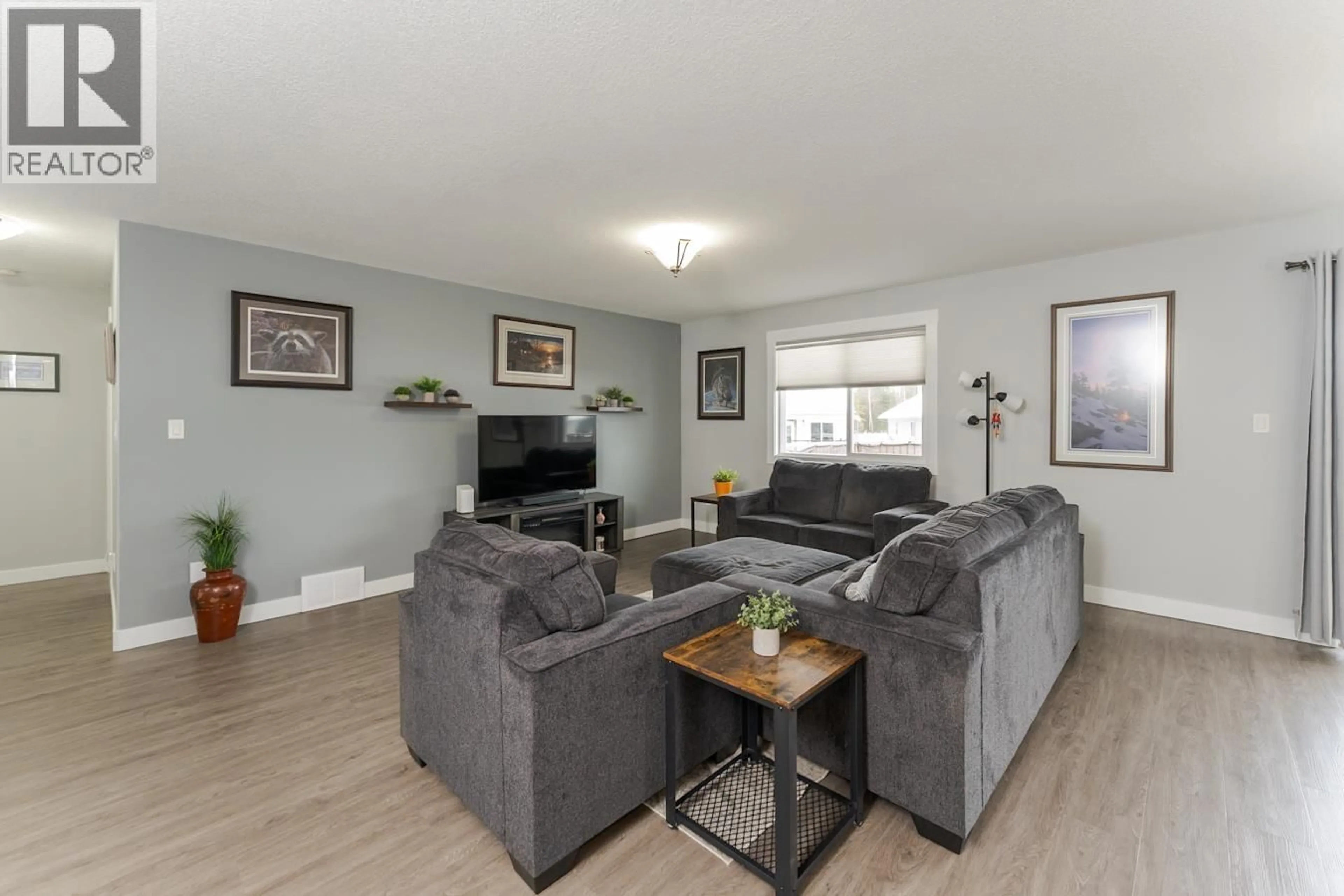 Living room with furniture, wood/laminate floor for 9060 TATLOW PLACE, Prince George British Columbia V2K0B5