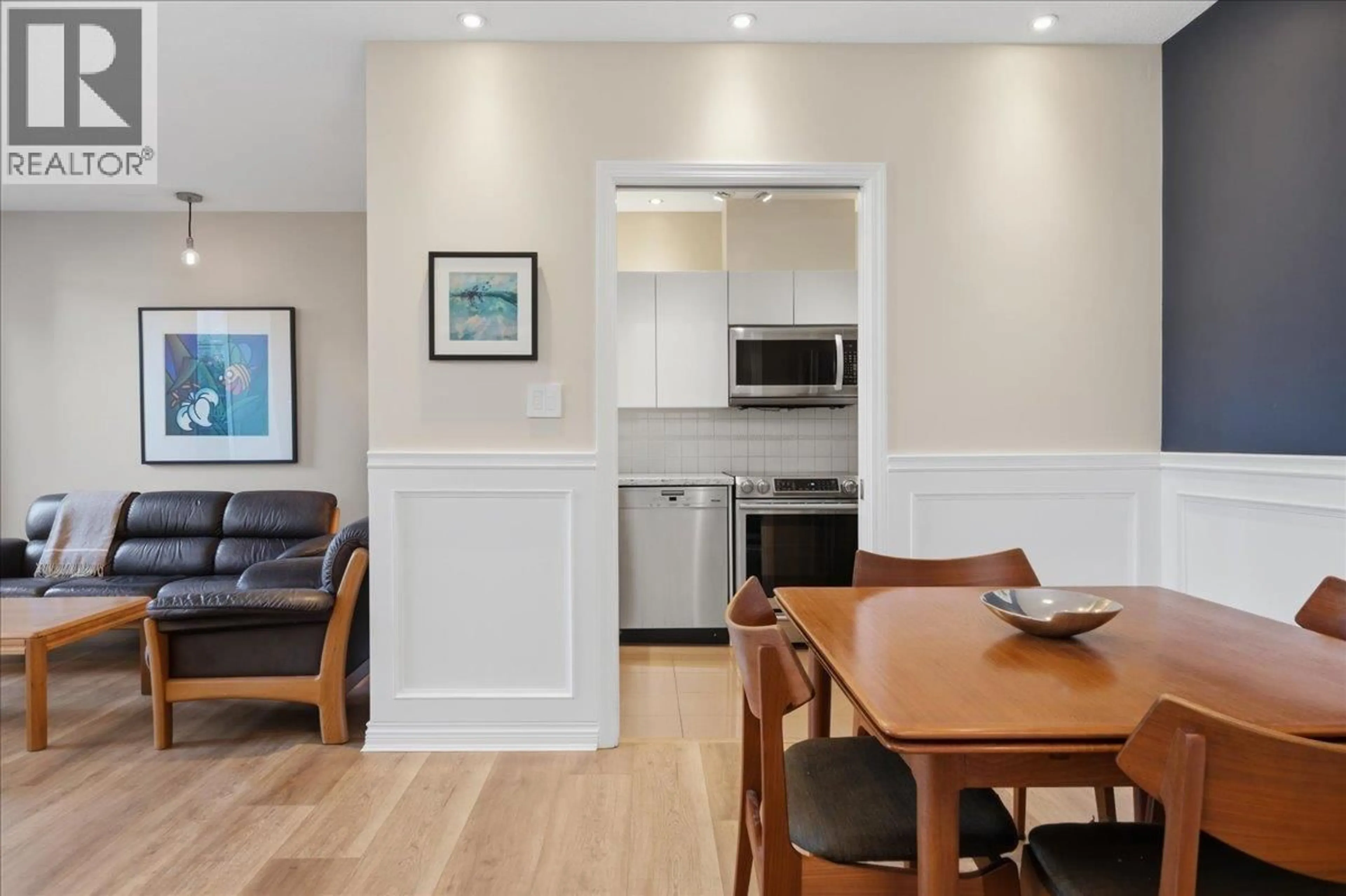 Open concept kitchen, wood/laminate floor for 202 - 2483 YEW STREET, Vancouver British Columbia V6K3H3