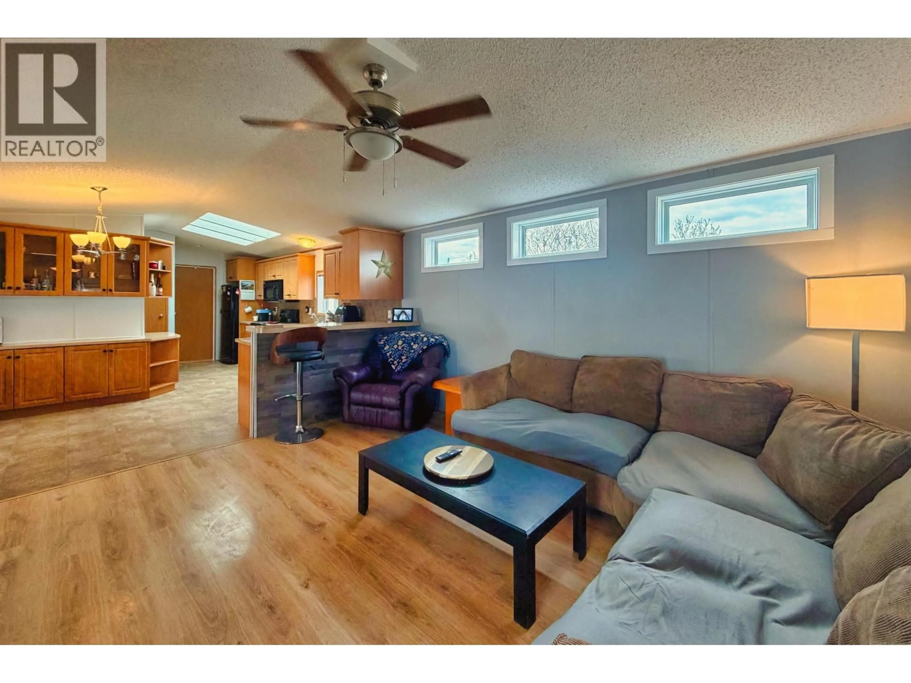 Living room with furniture, wood/laminate floor for 25 - 3001 MACKENZIE AVENUE, Williams Lake British Columbia V2G3N9