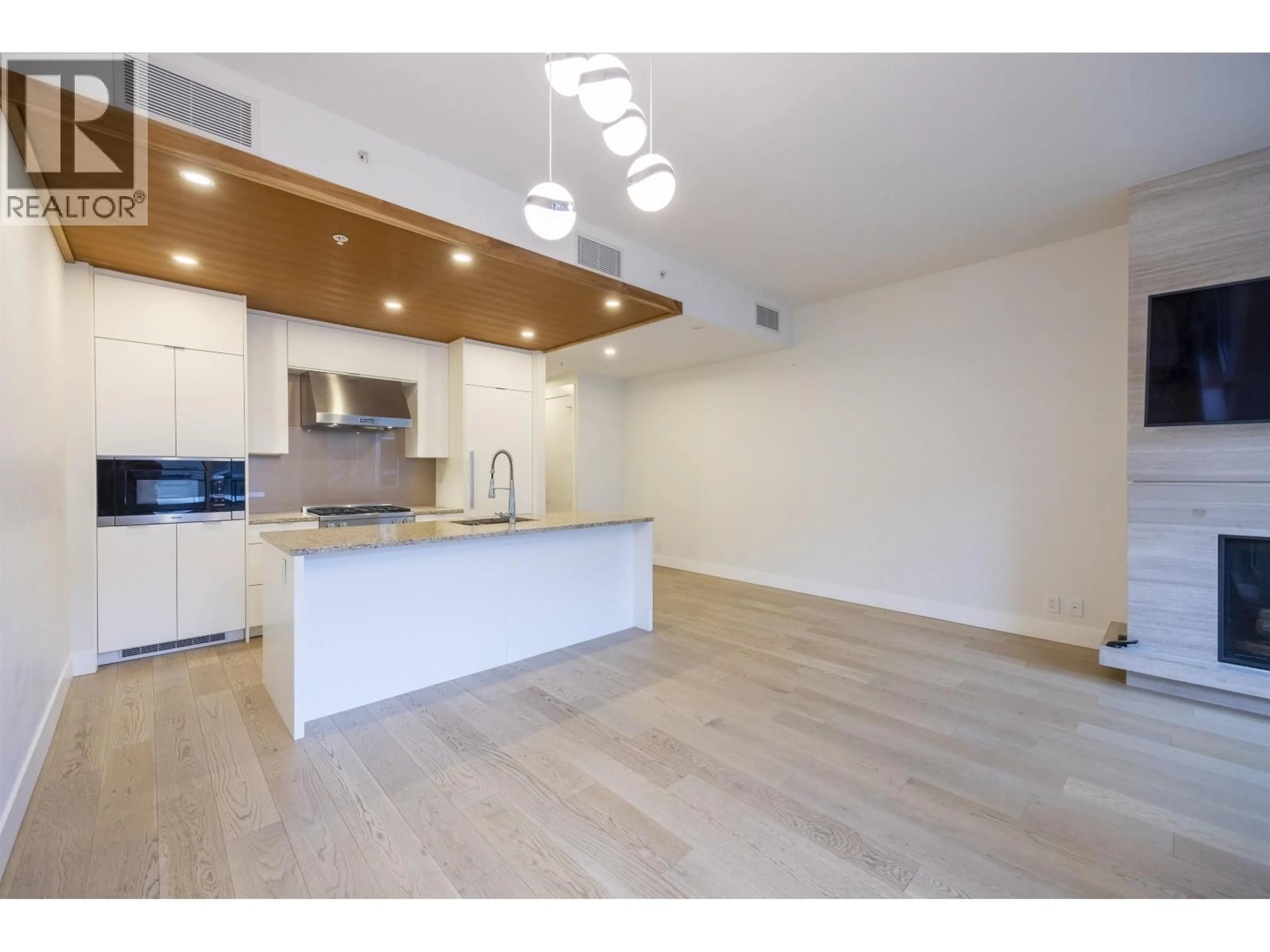 Open concept kitchen, wood/laminate floor for 306 - 6687 NELSON AVENUE, Vancouver British Columbia V7W2B2