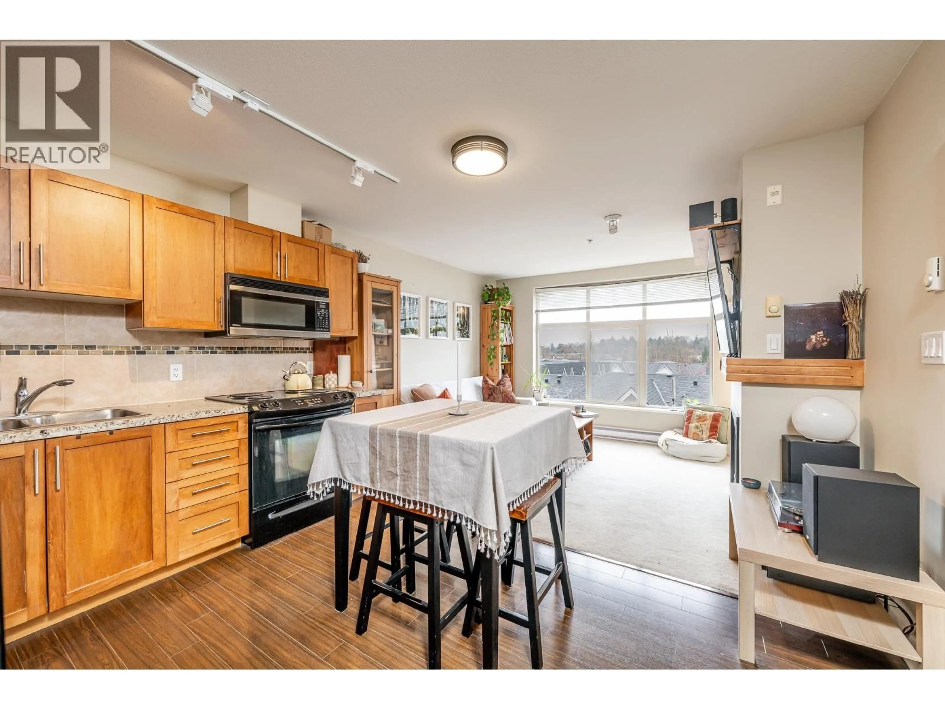 Open concept kitchen, wood/laminate floor for 421 - 1211 VILLAGE GREEN WAY, Squamish British Columbia V8B0R7