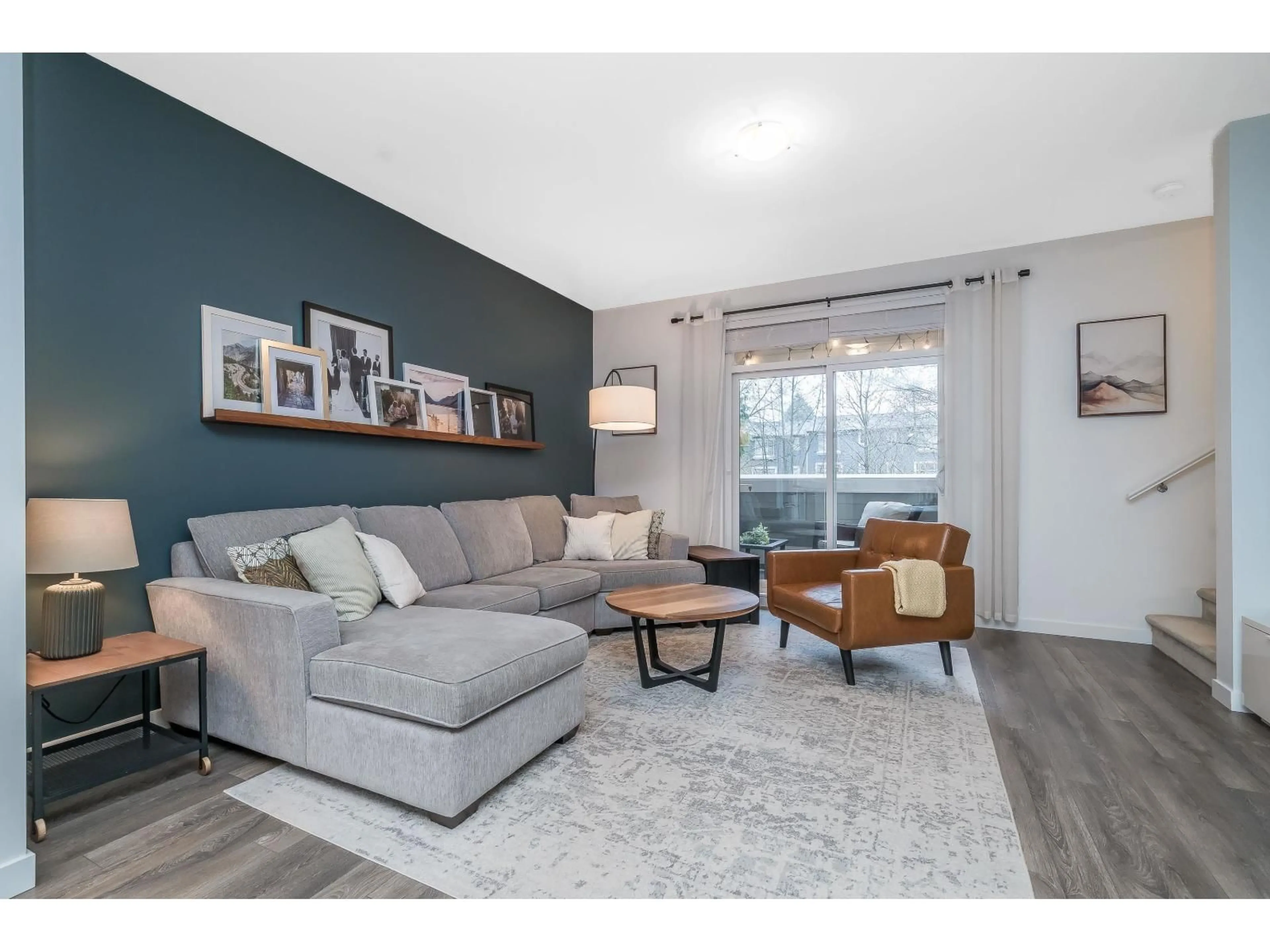 Living room with furniture, wood/laminate floor for 35 - 16357 15 AVENUE, Surrey British Columbia V4A0C2